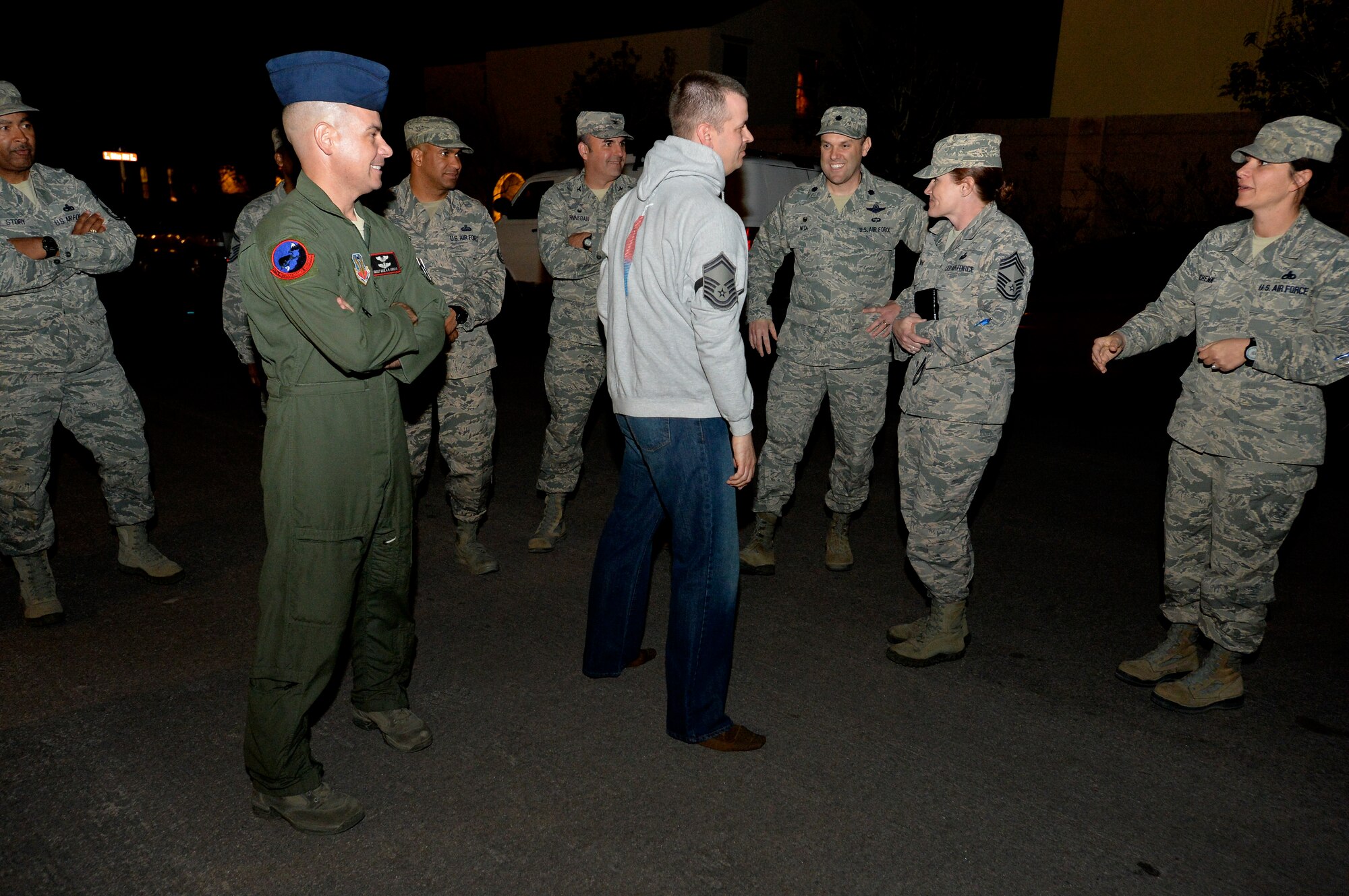 Master Sgt. Westley Girven 432nd Wing, center, is congratulated for reaching senior master sergeant by various members of Team Creech at his home, March 4, 2014. First sergeants, squadron commanders and chiefs were among the first to congratulate Creech Air Force Base’s 6 selectees, which included Airmen from the 432nd Wing. (U.S. Air Force photo by Senior Airman Adarius Petty/Released)