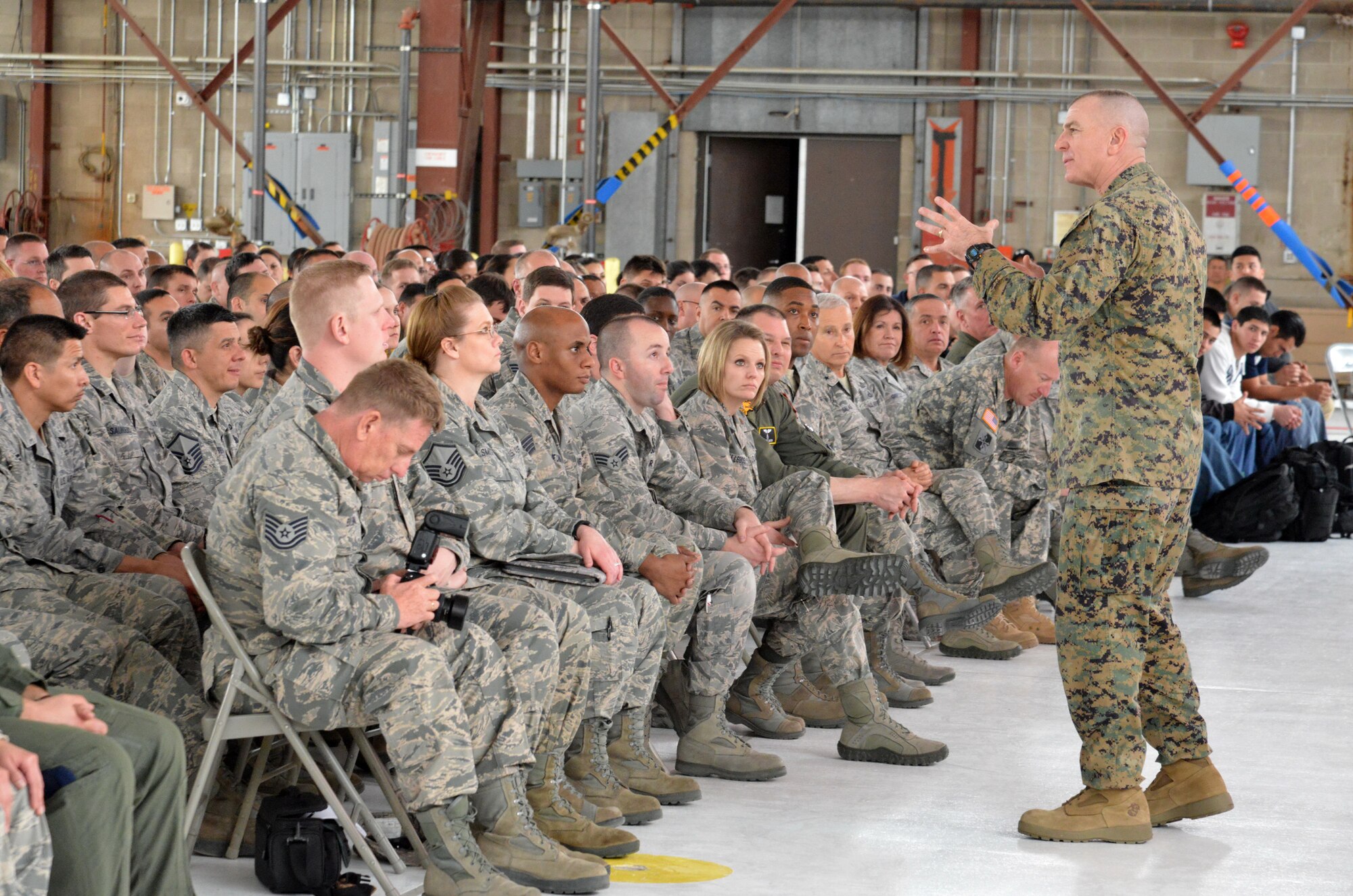Senior Enlisted Advisor to the Chairman, Joint Chiefs of Staff, Marine Sgt. Maj. Bryan B. Battaglia addresses troops from the 150th Special Operations Wing, New Mexico Air National Guard, during an all-call at Kirtland Saturday. Battaglia, the senior ranking enlisted member in the Department of Defense, visited Kirtland Saturday through Monday talking to Airmen about a range of issues affecting the force, from post-traumatic stress to financial planning to the potential reworking of the retirement benefits for active duty, reserve and Air National Guard members. (Photo by Ken Moore)