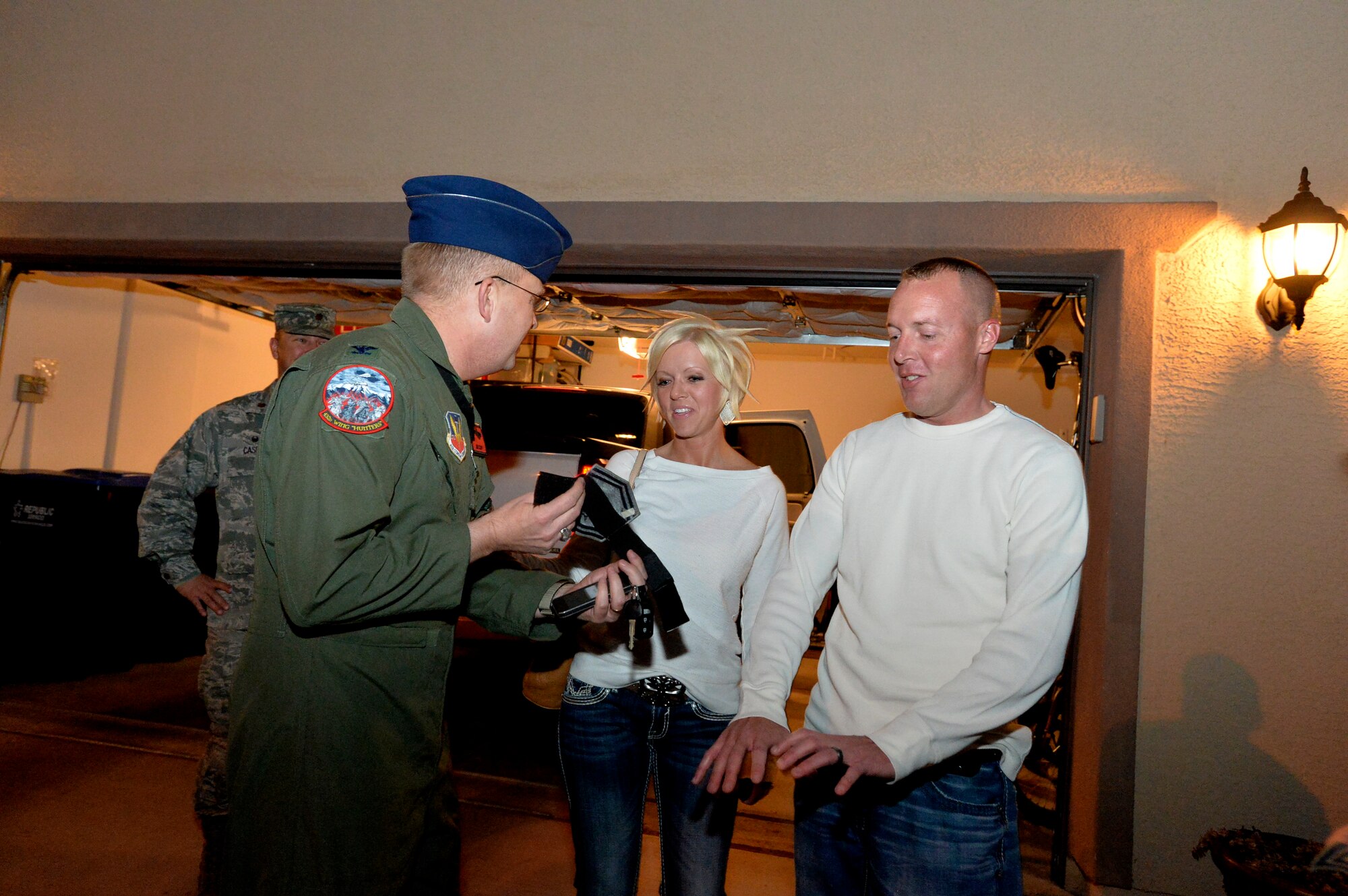 Col. James Cluff, 432nd Wing/432nd Air Expeditionary Wing commander, congratulates Master Sgt. Cary Thein, 432d Maintenance Squadron, production superintendent, on being selected for Senior Master Sergeant, March 4, 2014. Leadership from the 432nd WG/432nd AEW made sure that Creech Air Force Base’s newest senior master sergeants and their families were personally recognized for their achievements with an unexpected visit at their homes. (U.S. Air Force photo by Senior Airman Adarius Petty/Released)