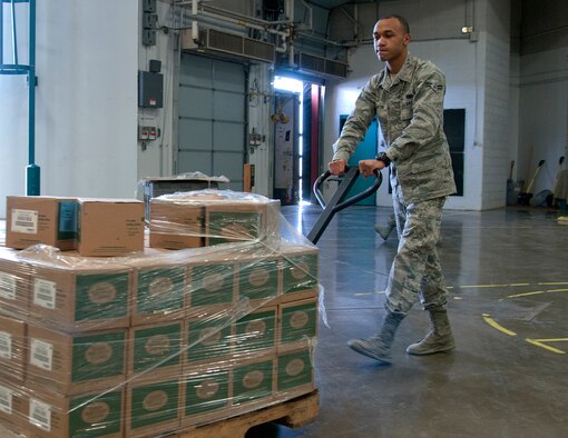 Airman 1st Class Russell McClinton, 790th Missile Security Forces Squadron Security Support Team, wheels out a pallet of coffee supplies March 3, 2015, in the 90th Logistics Readiness Squadron cargo area on F.E. Warren Air Force Base, Wyo. McClinton helped the 90th Missile Wing chaplains and the 90th LRS take inventory of the 28 pallets of coffee machines, coffee and mugs. (U.S. Air Force photo by Airman 1st Class Malcolm Mayfield)