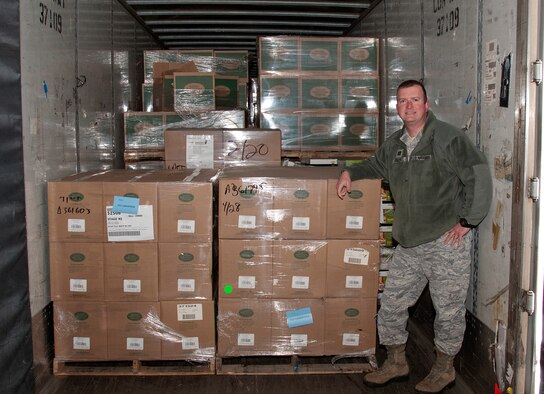 Chaplain (Capt.) Thomas Fussell, 90th Missile Wing chaplain, poses with the load of coffee machines, coffee and mugs March 3, 2015, in the 90th Logistic Readiness Squadron cargo area on F.E. Warren Air Force Base, Wyo. Fussell and Chaplain (Capt.) Robert Tilley, 90th MW chaplain, organized the delivery to replace machines in missile alert facilities and in common areas around base. (U.S. Air Force photo by Airman 1st Class Malcolm Mayfield)