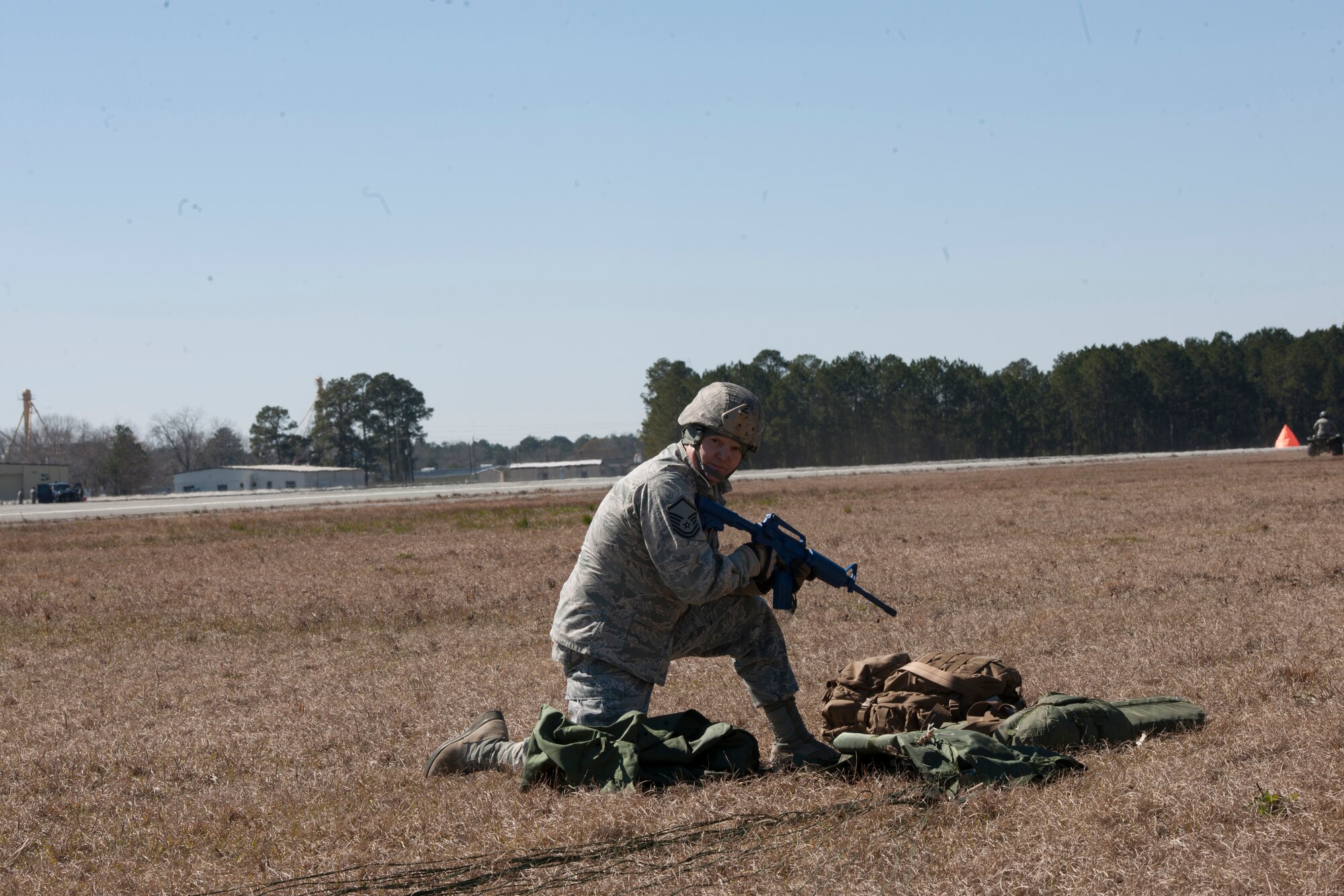 Master Sgt. David Brown, assumes a defensive position after completing a static line drop Feb. 19, 2015, at Tifton Air Field, Ga.  At a moment's notice, the group provides the expeditionary Air Force's only worldwide deployable, "first-in", fully integrated, multidisciplined, highly qualified, self-sustaining force protection capability. (U.S. Air Force photo by Staff Sgt. Eric Summers Jr./Released)