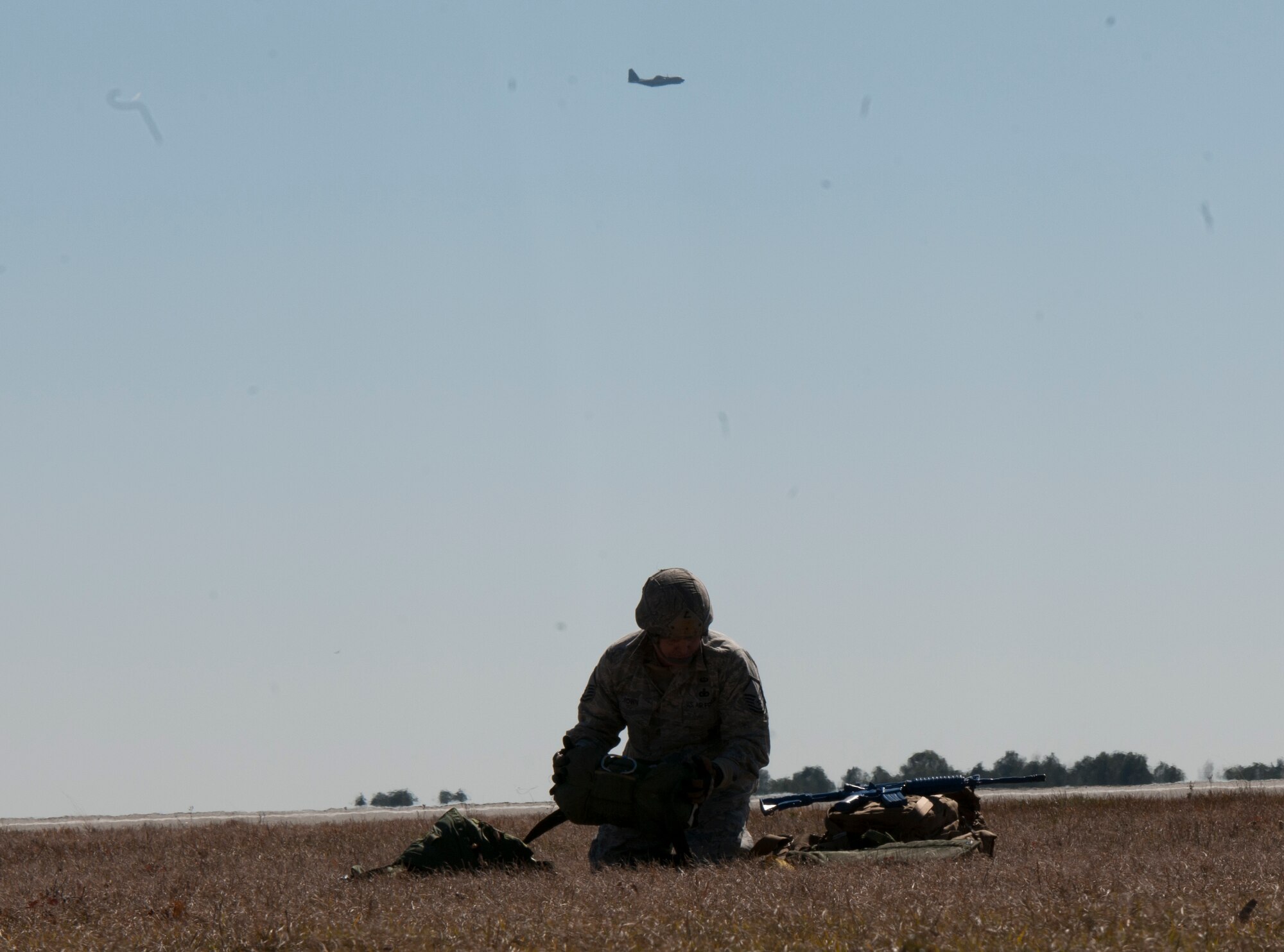 Master Sgt. David Brown, 820th Base Defense Group, gathers his gear after completing a static line drop from a C-130P Hercules Feb. 19, 2015, at Tifton Air Field, Ga.  The 820th BDG is the expeditionary Air Force's only worldwide deployable, first-in, self-sustaining force protection capability. (U.S. Air Force photo by Staff Sgt. Eric Summers Jr./Released)