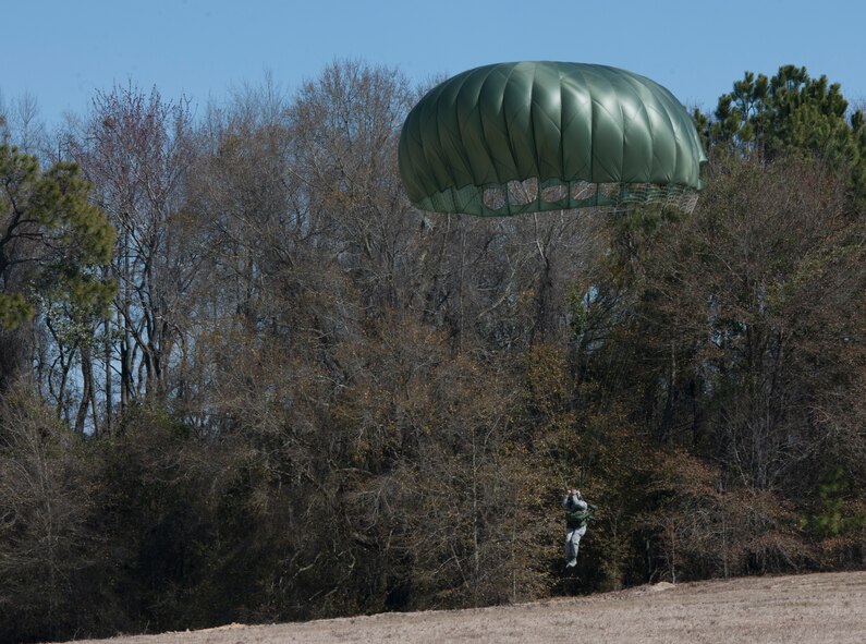 An Airman from the 820th Base Defense Group uses landing techniques during a static line drop Feb. 19, 2015, at Tifton Air Field, Ga. The Airmen practice safe landing techniques multiple times to ensure they are able to land without obtaining injuries themselves. (U.S. Air Force photo by Staff Sgt. Eric Summers Jr./Released)