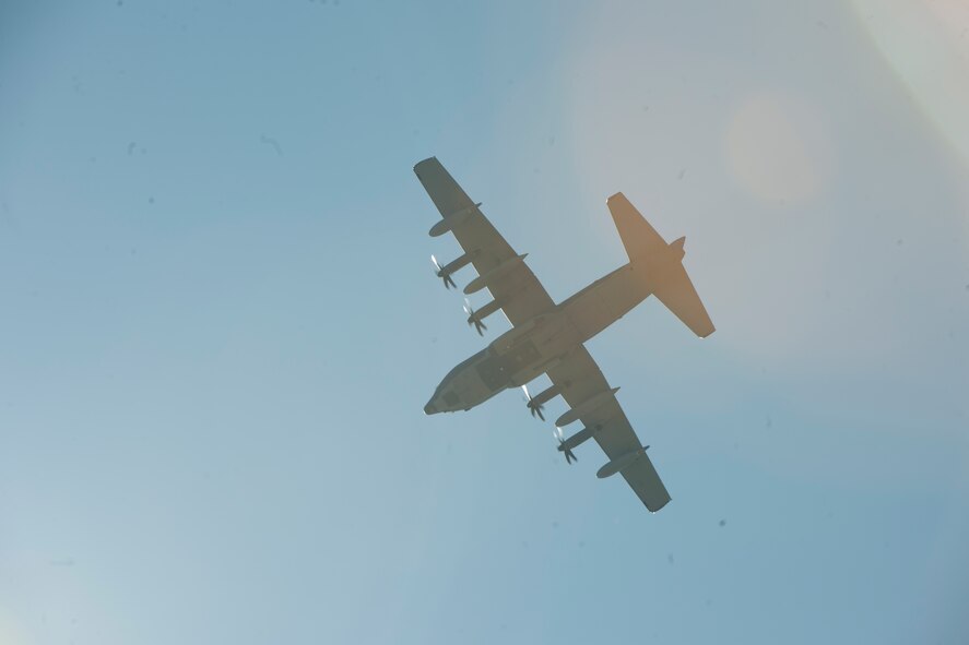 A C-130J Hercules passes overhead before members of the 820th Base Defense Group exit the aircraft for a static line jump Feb. 19, 2015, at Tifton Air Field, Ga. The first pass of the aircraft was to ensure that the area was safe before releasing Airman to jump out. (U.S. Air Force photo by Staff Sgt. Eric Summers Jr./Released)