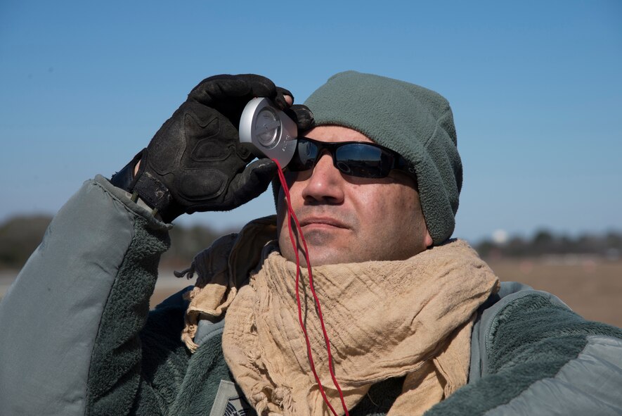 Master Sgt. Timothy Bhan, 820th Base Defense Group, watches how a balloon rises to report the angle and displacement before a static line drop Feb. 19, 2015, at Tifton Air Field, Ga. The change in the balloons direction and its rate of rise are used to calculate wind trajectory and change. (U.S. Air Force photo by Staff Sgt. Eric Summers Jr./Released)