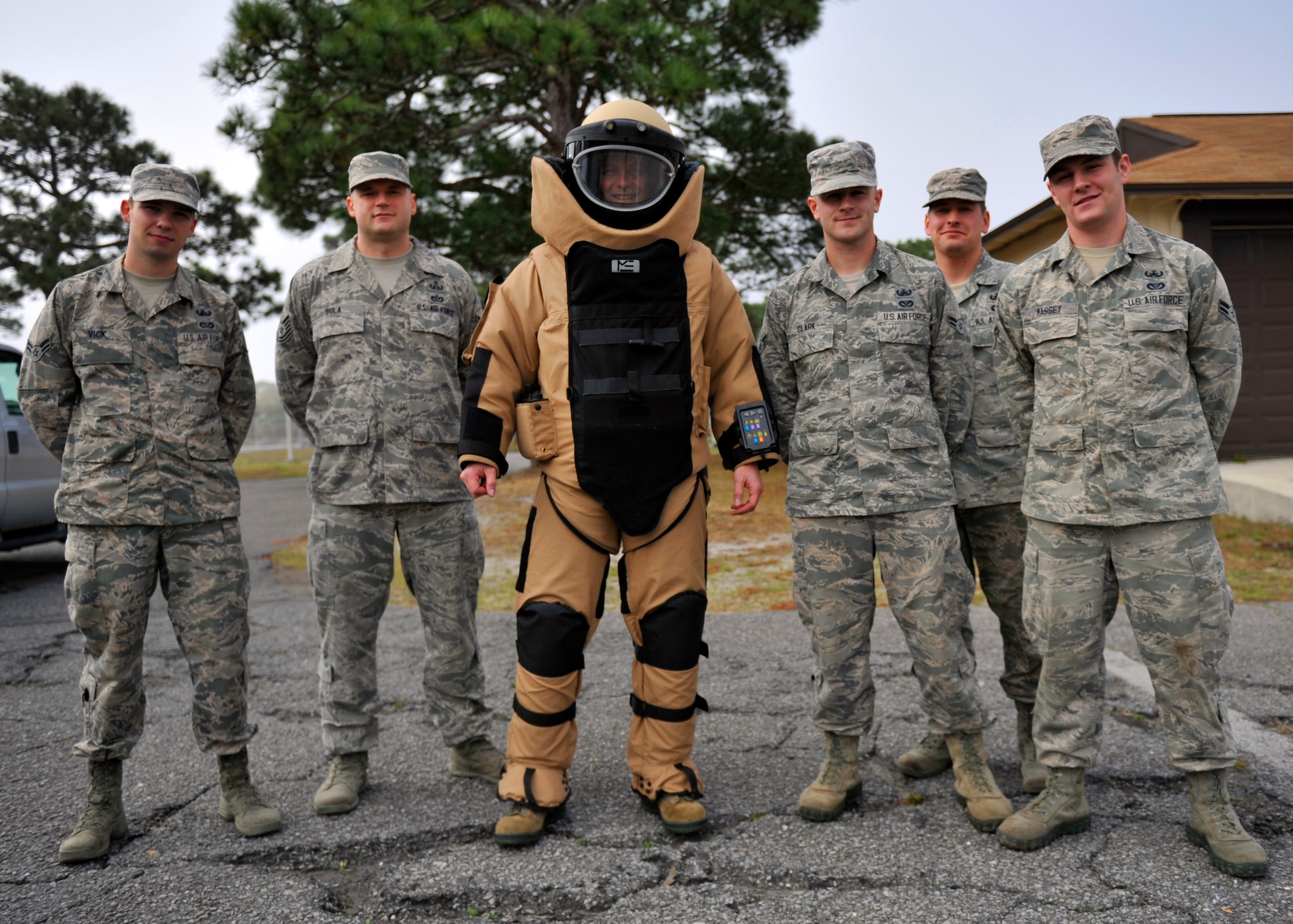 Colonel Derek C. France, 325th Fighter Wing commander, dons an Explosive Ordnance Disposal 9 bomb suit during a group shot with Airmen from the 325th Civil Engineer Squadron EOD unit March 5 at the EOD facility. Once a month, France shadows an Airman as part of the Airman Shadow Program. (U.S. Air Force photo by Airman 1st Class Sergio A. Gamboa/Released)