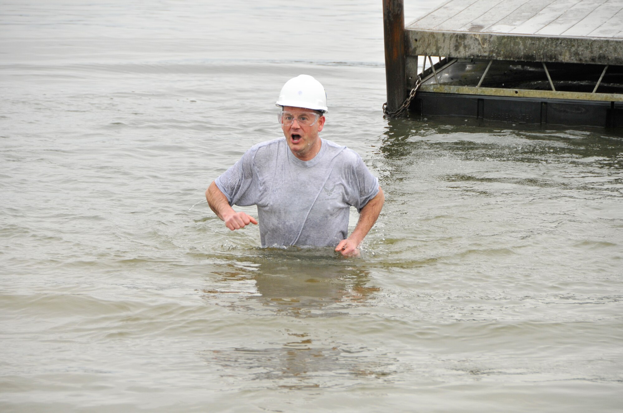 Tennessee has experienced frigid temperatures and snowy weather recently, but this didn’t stop a group of officers, government civilians and contractors from jumping into the freezing Woods Reservoir on Wednesday, Feb. 25. The high for that day was 36 degrees Farenheit. The Company Grade Officers’ Council (CGOC) hosted its Polar Bear Plunge, a fundraiser in which donations are pledged in someone’s name and then he or she must either pay up or take a leap into the lake. All donations go toward events and charities on base or in the local area that are supported by the CGOC. Pictured here in these photos is Lt. Col. Jay Orson as he takes his plunge. (Photos by Jacqueline Cowan)