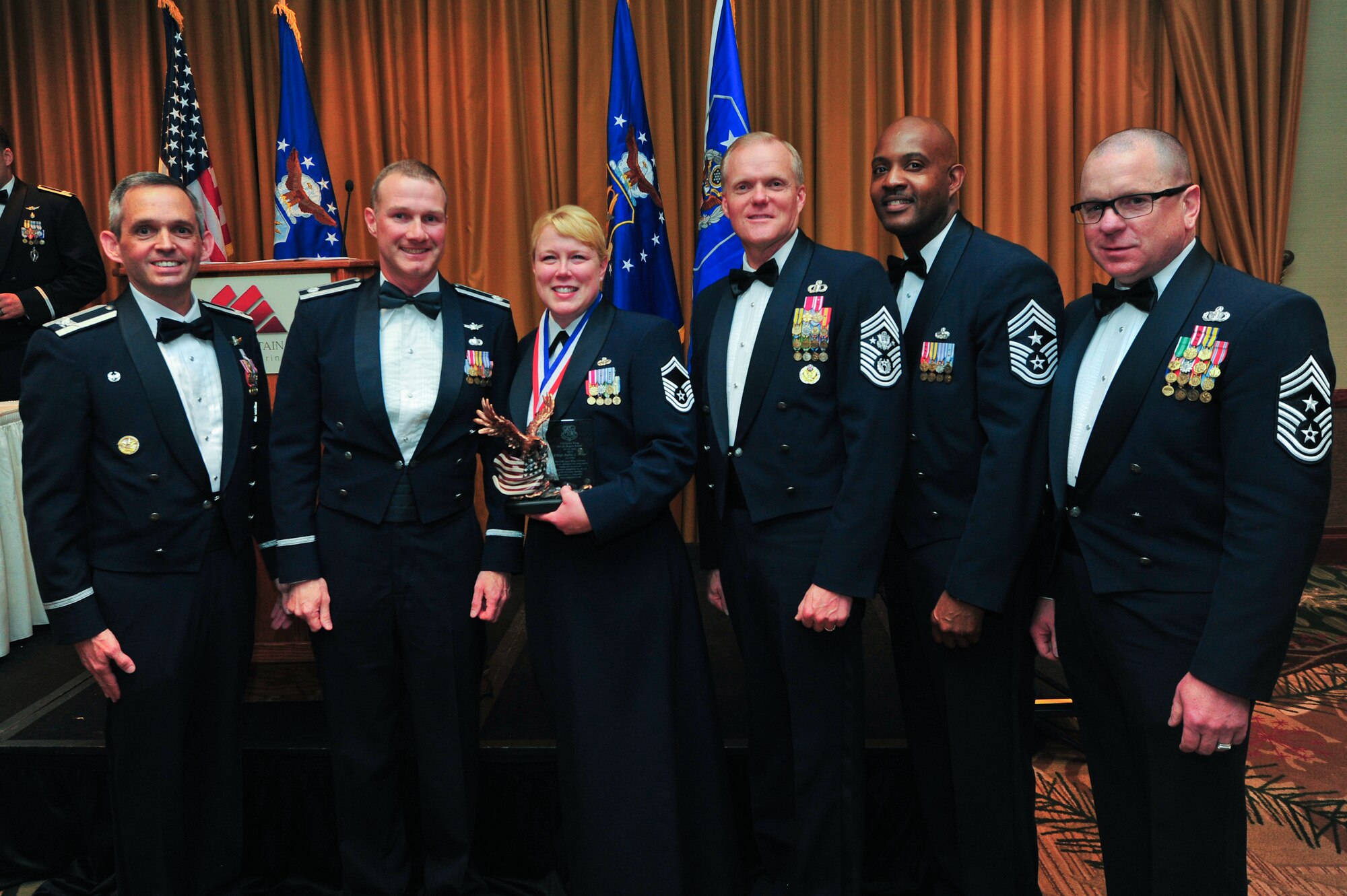 Air Force Reserve Col. Damon S. Feltman, Lt. Col Adam D. Rogers, Senior Master Sgt. Andrea L. Fisher, Chief Master Sgt. of the Air Force James A. Cody, Chief Master Sgt. Cameron B. Kirksey and Chief Master Sgt. Gary Brown pose for the “Dee Jai Rogers Award” awarded to Fisher March 6, 2015, during the 310th Space Wing's Annual Awards Banquet at the Cheyenne Mountain Resort in Colorado Springs, Colo. The wing sponsored the event to both recognize its annual award winners and bring Reservists together to enjoy an evening of esprit de corps, unit morale and camaraderie.
(U.S. Air Force photo/Tech. Sgt. Nicholas B. Ontiveros)