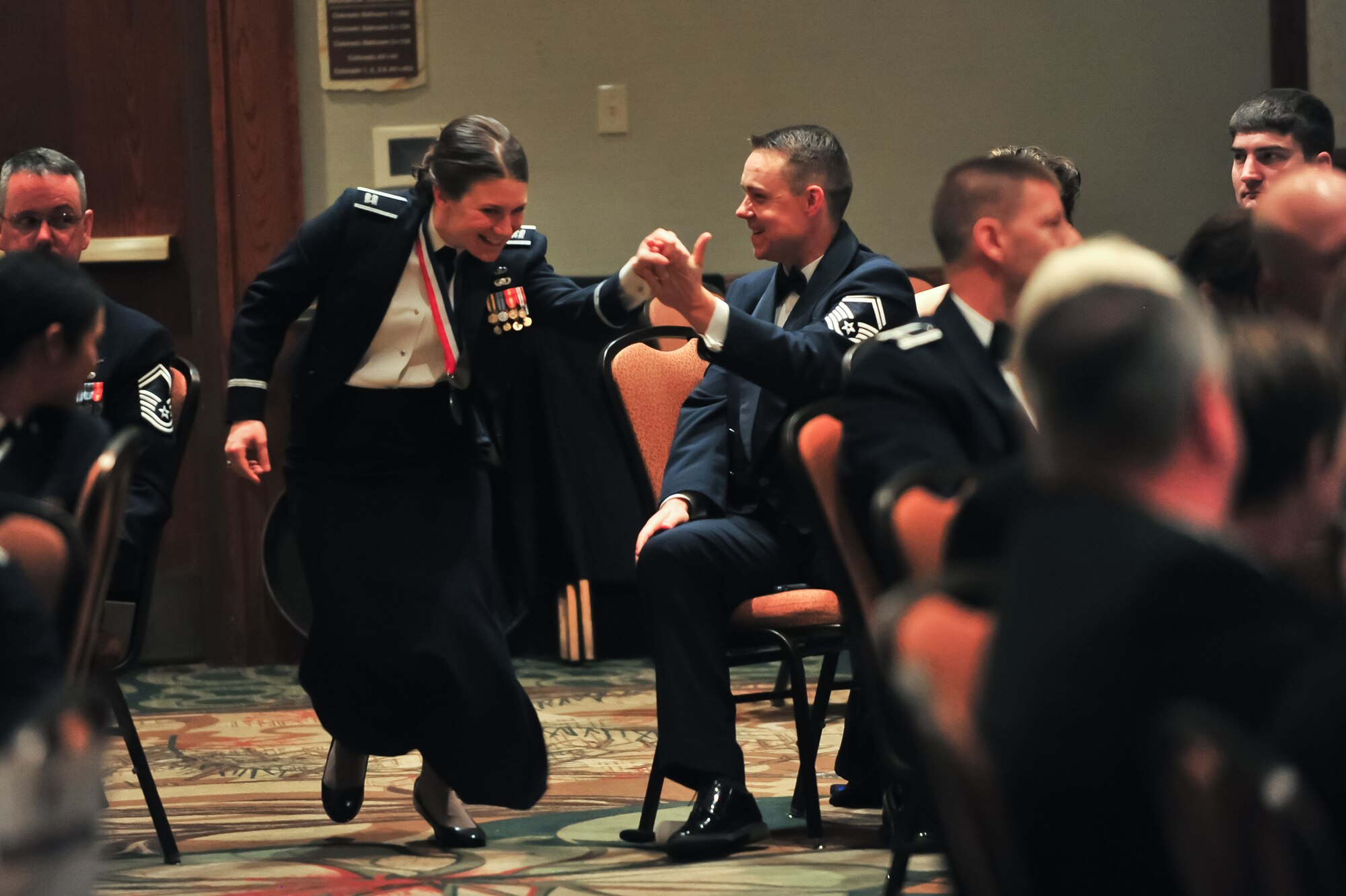 Air Force Reserve Capt. April C. Harker runs with excitement to receive her award March 6, 2015, during the 310th Space Wing's Annual Awards Banquet at the Cheyenne Mountain Resort in Colorado Springs, Colo. The wing sponsored the event to both recognize its annual award winners and bring Reservists together to enjoy an evening of esprit de corps, unit morale and camaraderie.
(U.S. Air Force photo/Tech. Sgt. Nicholas B. Ontiveros)