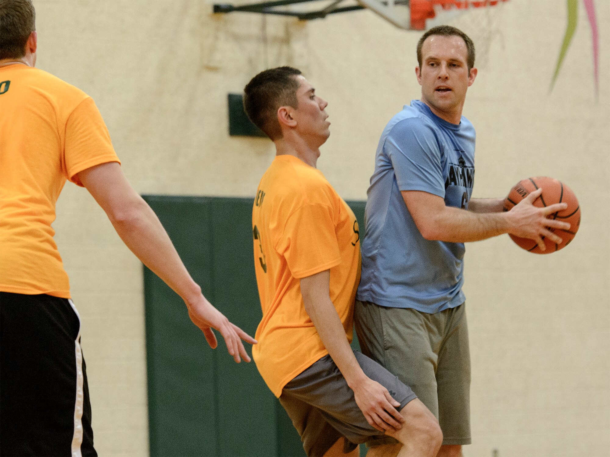 VANCE AIR FORCE BASE, Okla. -- 3rd Flying Training Squadron team captain Charlton Coats looks for an open teammate at Bradley Fitness and Sports Center, Feb. 25. Coats had 11 points in the Jayhawks’ eighth win in a row. (U.S. Air Force photo / David Poe)