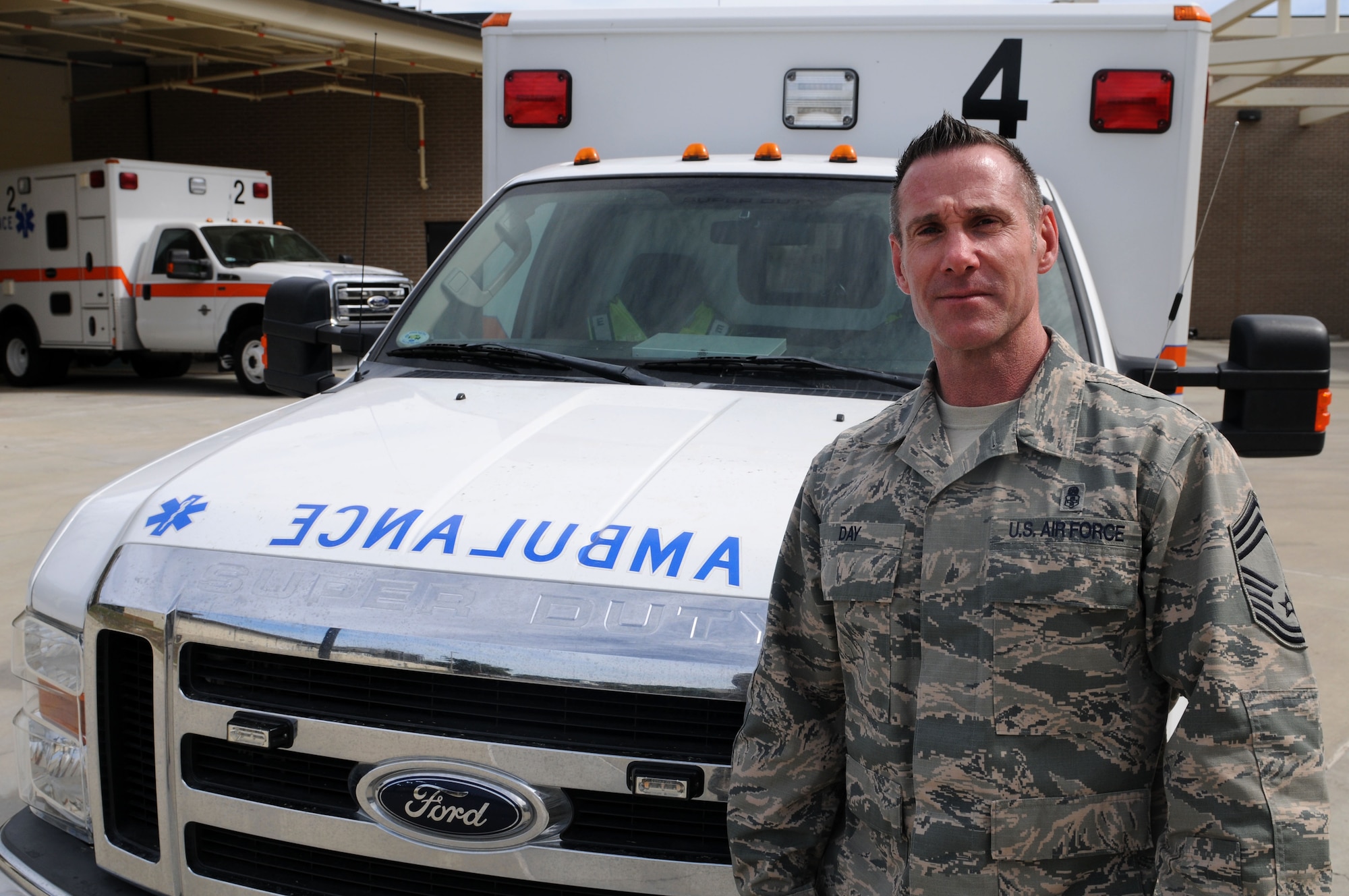 Chief Master Sgt. Karl Day, 81st Medical Group superintendent, poses for a photo in front of the Keesler Medical Center’s ambulances March 6, 2015, Keesler Air Force Base, Miss. Day arrived at the beginning of the month, following his assignment as the aerospace medicine functional manager for U.S. Air Forces in Europe and Air Forces Africa at Ramstein Air Base, Germany. (U.S. Air Force photo by Airman 1st Class Duncan McElroy)