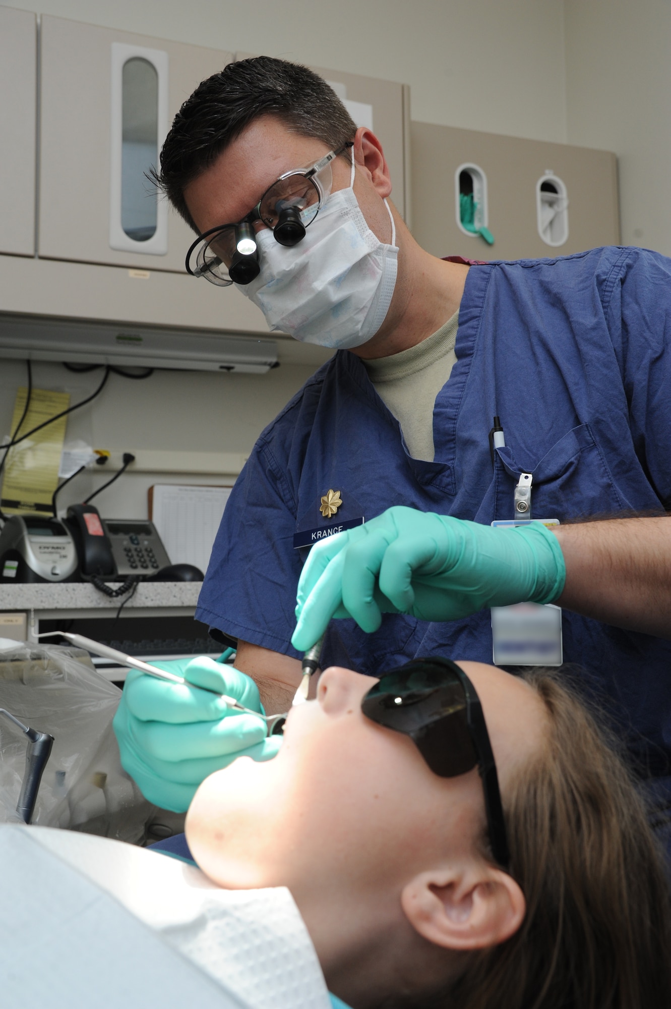 Maj. (Dr.) Aaron Krance, 81st Dental Squadron advanced education in general dentistry resident, performs a dental exam on Peytyn Ferdelman Feb. 25, 2015, at the dental clinic, Keesler Air Force Base, Miss.  Peytyn is the daughter of retired Coast Guard member William Ferdelman. The 81st DS is home to approximately 11 dental officers who undergo training in either a one-year Advanced Education in General Dentistry, a General Practice Residency, a 2-year Endodontic residency program, or a Fellowship program in implant dentistry. The Dental Clinic appointment number is (228)376-0511 (DSN: 591-0511).  (U.S. Air Force photo by Kemberly Groue)