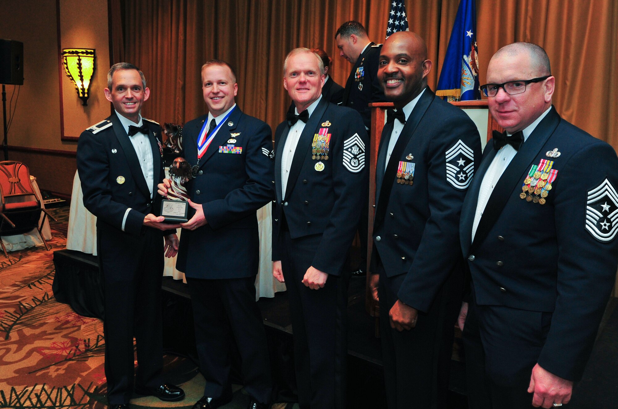 Air Force Reserve Col. Damon S. Feltman, Senior Airman James E. Kettunen, Chief Master Sgt. of the Air Force James A. Cody, Chief Master Sgt. Cameron B. Kirksey and Chief Master Sgt. Gary Brown pose for the “Airman of the Year Award” presented to Kettunen March 6, 2015, during the 310th Space Wing's Annual Awards Banquet at the Cheyenne Mountain Resort in Colorado Springs, Colo. The wing sponsored the event to both recognize its annual award winners and bring Reservists together to enjoy an evening of esprit de corps, unit morale and camaraderie.
(U.S. Air Force photo/Tech. Sgt. Nicholas B. Ontiveros)