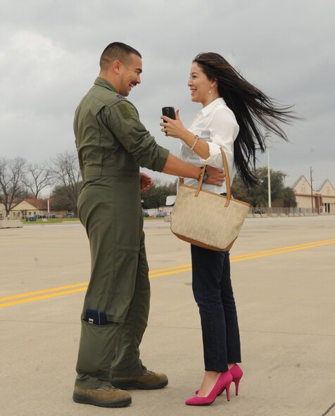 Capt. Justin Adkins, 96th Bomb Squadron, embraces his wife on Barksdale Air Force Base, La., March 4, 2015, after returning from a deployment from Andersen Air Force Base, Guam. Airmen deployed to Guam perform the same mission they do at Barksdale; however, they perform it under a different command, United States Pacific Command. (U.S. Air Force photo/Senior Airman Kristin High)