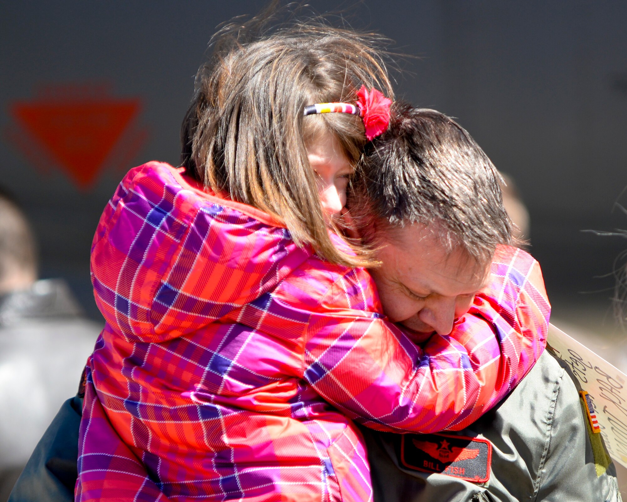 Maj. William Fish, 96th Bomb Squadron, hugs his daughter on Barksdale Air Force Base, La., March 6, 2015, after returning from a deployment from Andersen Air Force Base, Guam. Fish spent six months deployed to Guam, providing long range strike capability in the Pacific region. (U.S. Air Force photo/Senior Airman Benjamin Raughton)