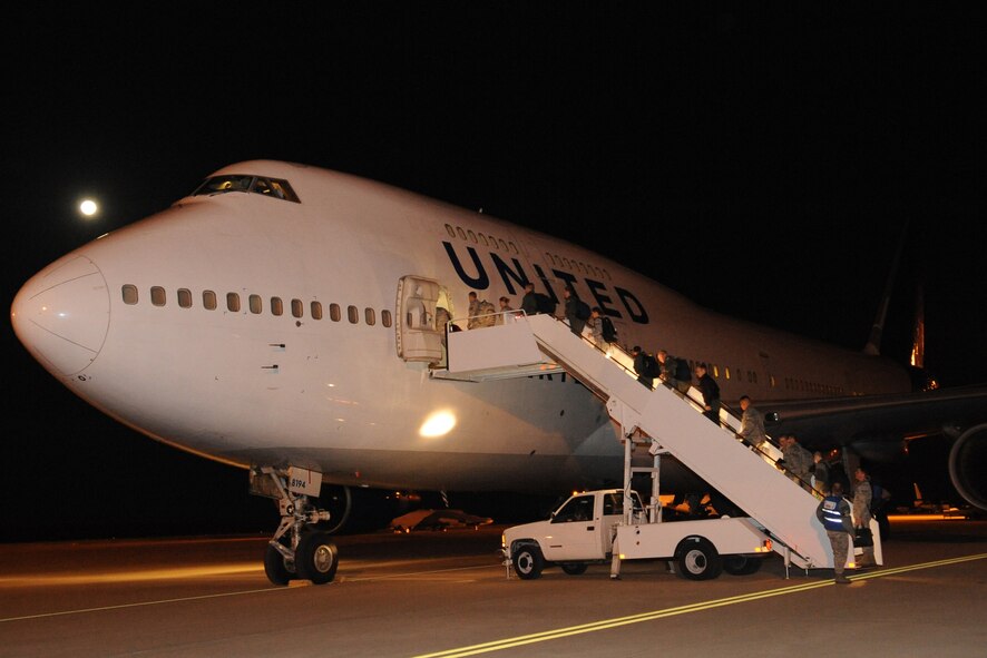 Airmen from the 2nd Bomb Wing board a flight to Guam for a deployment from Barksdale Air Force Base, La., March 6, 2015. B-52H Stratofortress bombers and aircrew from the 96th Bomb Squadron, and 2nd BW Airmen, are deploying in support of the continuous bomber presence in the Pacific, a standing Air Force Global Strike Command deterrence mission. (U.S. Air Force photo/Senior Airman Kristin High)