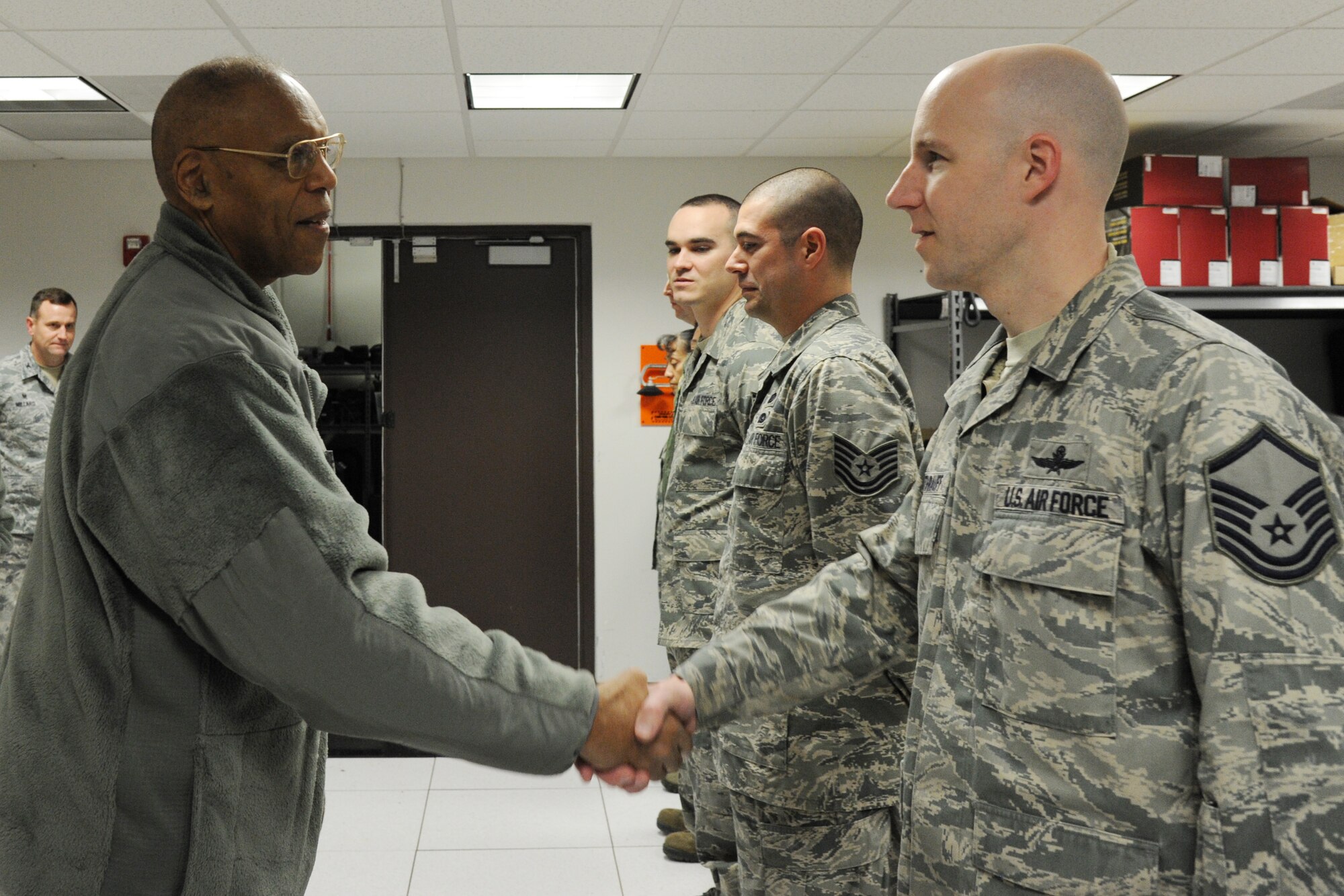Air Force Vice Chief of Staff Gen. Larry Spencer coins Master Sgt. Brian Ruthrauff during a his visit to Joint Base Andrews, Md., March 6, 2015. Ruthrauff is a member of the Secretary of Defense Executive Travel Communications Team which provides communications support to the Secretary of Defense as he travels across the globe. (U.S. Air Force photo/Master Sgt. Tammie Moore)