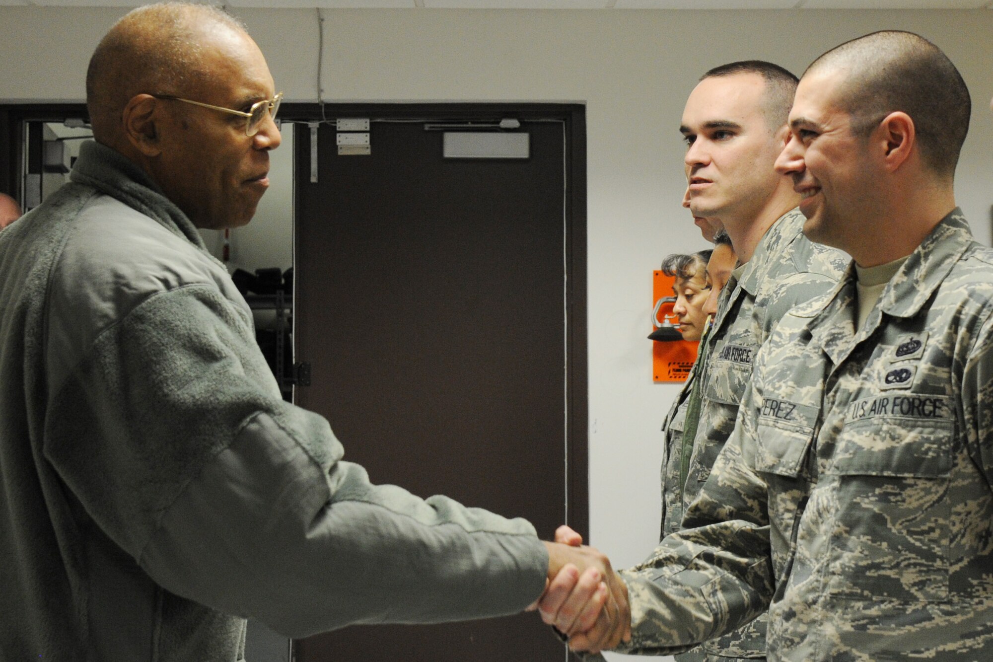 Air Force Vice Chief of Staff Gen. Larry Spencer coins Tech. Sgt. John Perez during a his visit to Joint Base Andrews, Md., March 6, 2015. Perez is a member of the Secretary of Defense Executive Travel Communications Team which provides communications support to the Secretary of Defense as he travels across the globe. (U.S. Air Force photo/Master Sgt. Tammie Moore)