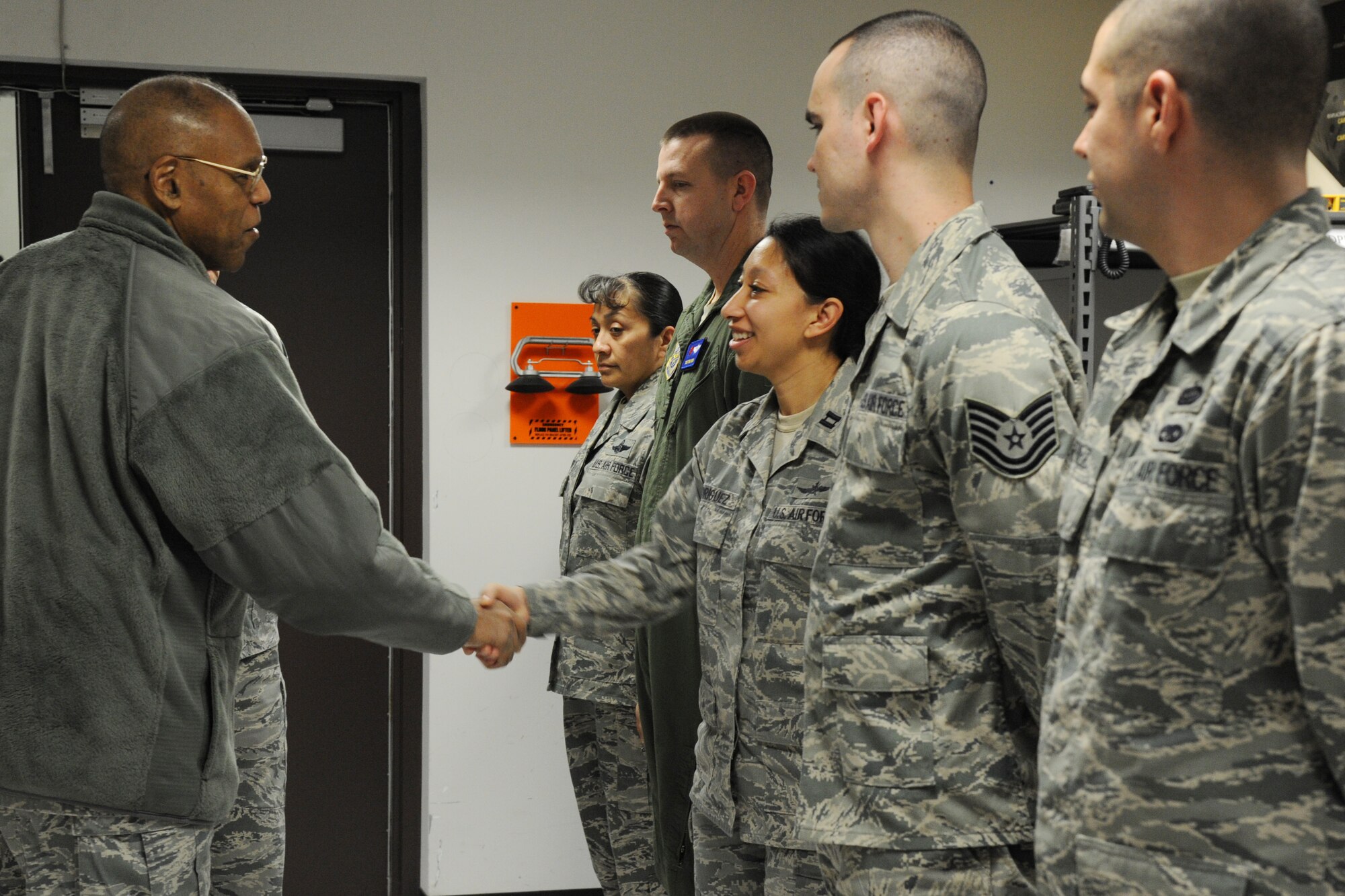 Air Force Vice Chief of Staff Gen. Larry Spencer coins Capt. Patricia Rodriguez during his visit to Joint Base Andrews, Md., March 6, 2015. Rodriquez is the 89th Airlift Support Group director of operations. (U.S. Air Force photo/Master Sgt. Tammie Moore)