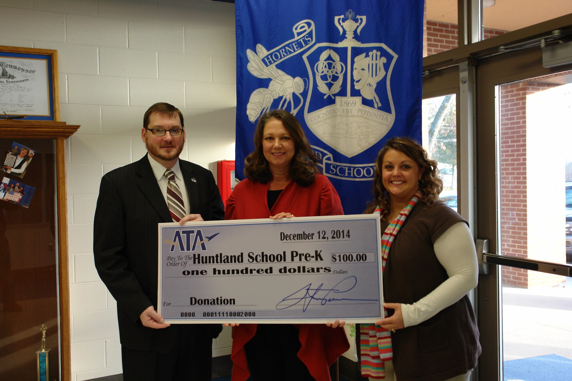 The Huntland School Pre-K department recently received a $100 donation from the Aerospace Testing Alliance (ATA) Employee and Community Activities Committee (E&CAC) for the Hatch iStartSmart App. With iStartSmart, students can engage in activities that develop readiness skills, teachers can access individual progress reports and parents can view progress in 18 skills areas. Pre-K Teacher Carlene Tucker (center) and Principal William Bishop II (left) accept the donation check from ATA E&CAC committee member Andrea Stephens. (Photo by J.C. Stephens)