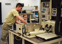 Staff Sgt. Christopher Setts, 341st Maintenance Operations Squadron electronics lab team chief (left), performs a checkout of a communications drawer as Airman 1st Class Rachel Barnes, 341st MOS ELAB technician, assists during a routine maintenance session March 5. For the checkout, a ground maintenance automated test station is used to evaluate the systems components and ensure the equipment is ready to be placed back into a live facility.  (U.S. Air Force photo/Airman 1st Class Collin Schmidt)