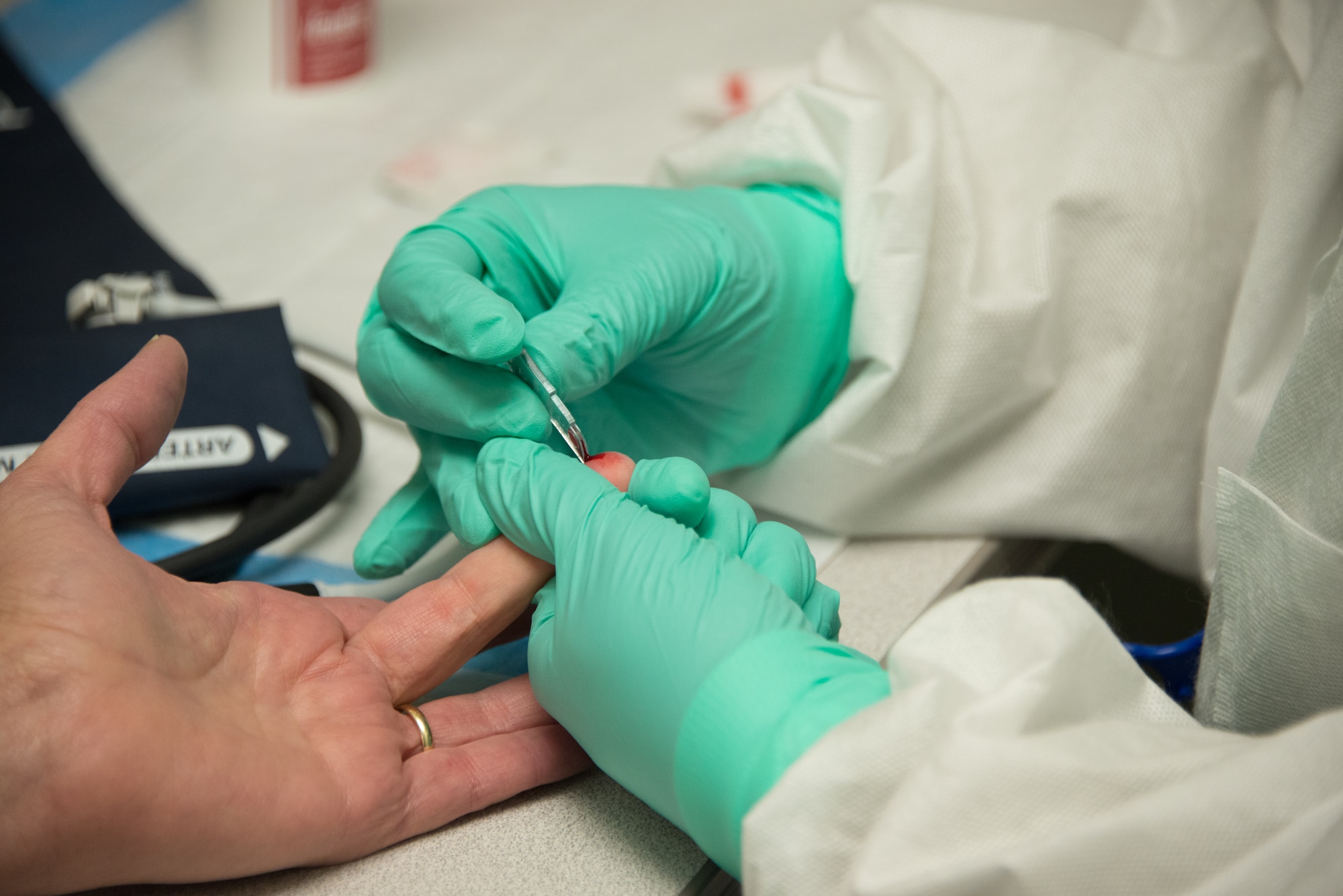 Tech. Sgt. Tarissa Brown, 403rd Aerospace Staging Squadron lab technician, checks iron levels of Susan Gardner, 334th Training Squadron commander support staff, prior to her donating blood March 6, 2015, at the blood donor center, Keesler Air Force Base, Miss. Gardner tries to donate blood every 56 days. (U.S. Air Force photo by Marie Floyd)