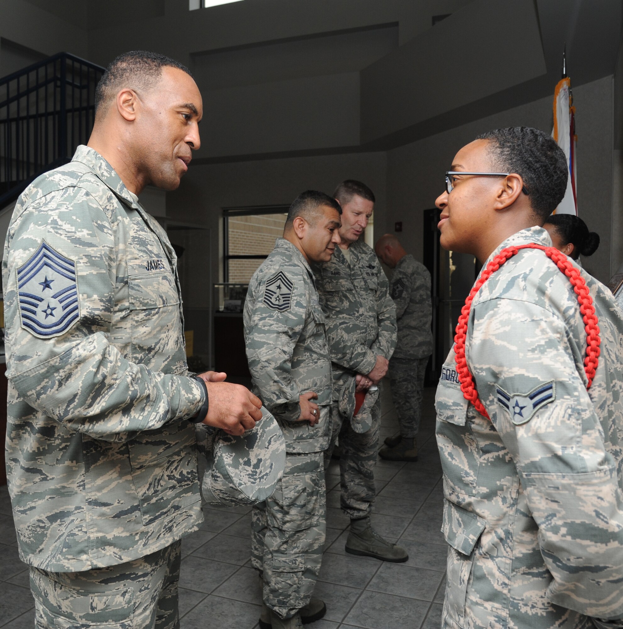Chief Master Sgt. Maurice James, 59th Medical Wing command chief, Lackland Air Force Base, Texas, speaks with Airman 1st Class Breanna Jackson, 335th Training Squadron, during the Air Education and Training Command Senior Leader Conference March 4, 2015, at the Levitow Training Support Facility, Keesler Air Force Base, Miss. Commanders and chief master sergeants from across AETC attended the conference, which gave senior leaders an opportunity to collaborate and share ideas as they shape the future of the command.  (U.S. Air Force photo by Kemberly Groue)