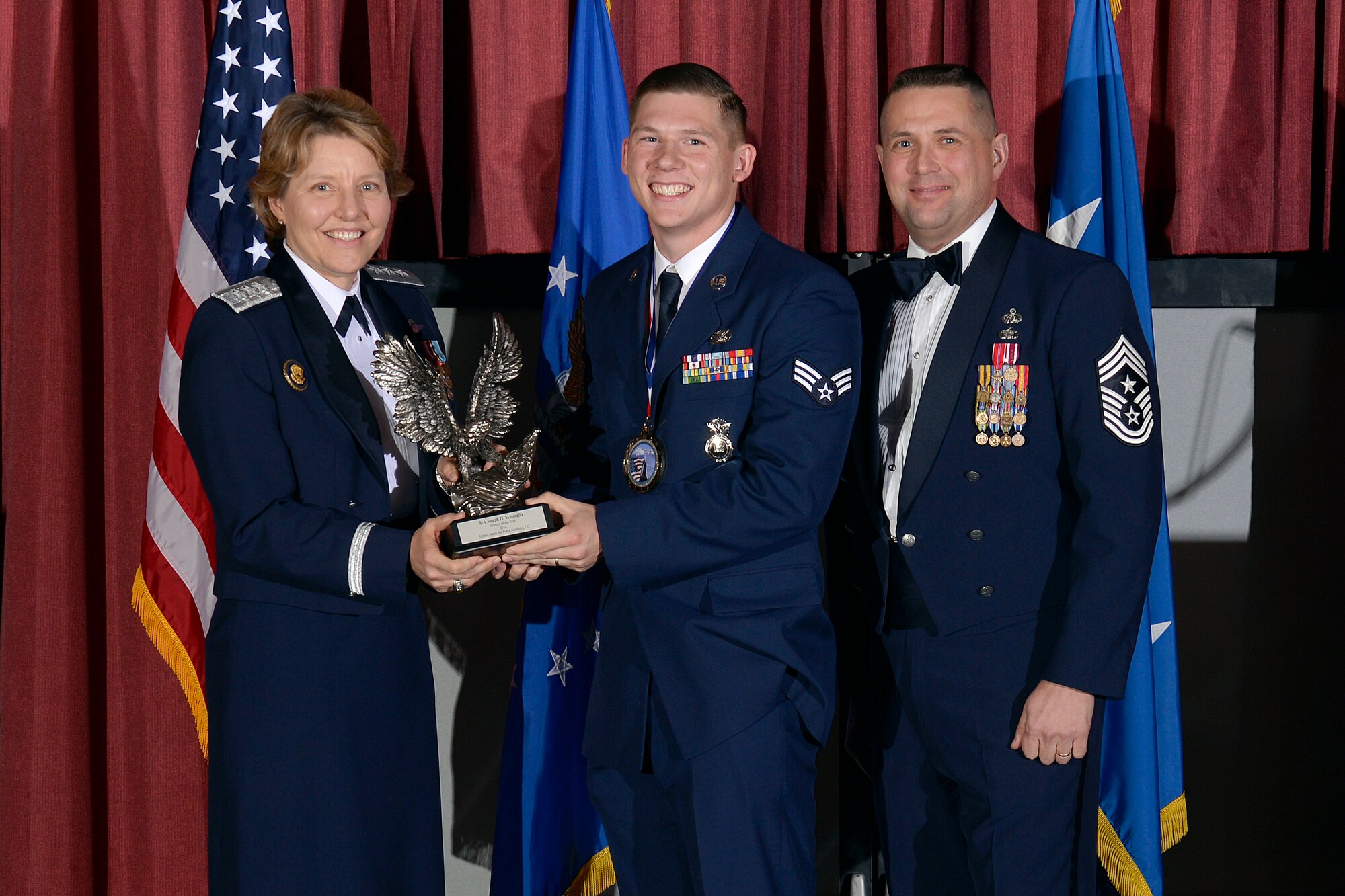 Chief Master Sgt. Maxwell Grindstaff, right, present Senior Airman Joseph
Massoglia with the Academy Airman of the Year award during the Annual Awards
Banquet at the Falcon Club March 5, 2015. Massoglia, a member of the 10th
Security Forces Squadron, was one of many service members and civilians
honored at the banquet. (U.S. Air Force photo/Jason Gutierrez)
