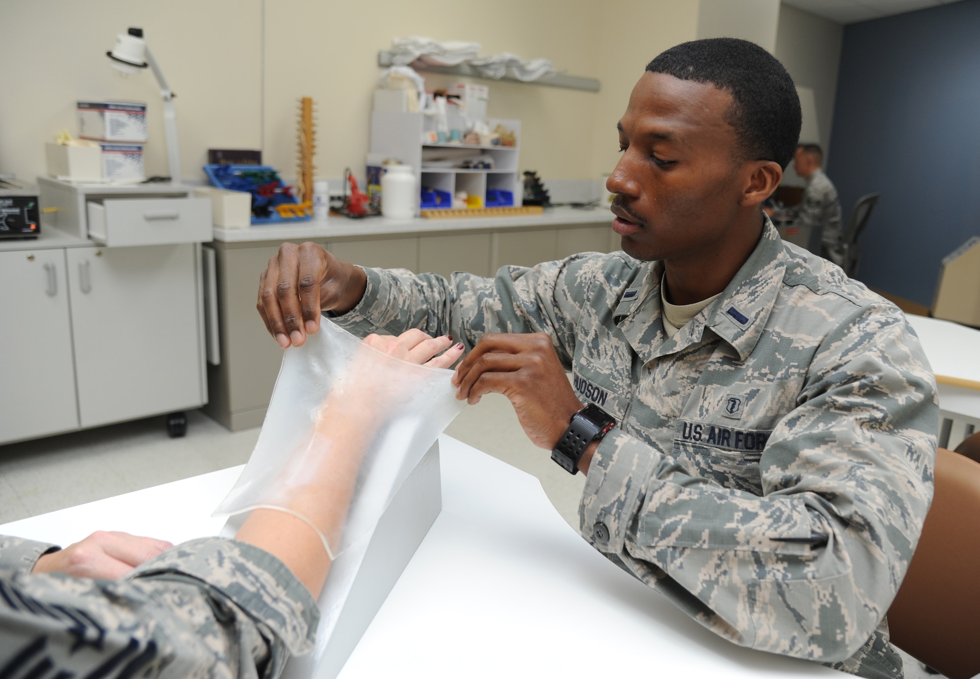 First Lt. Jabari Hudson, 81st Surgical Operations Squadron occupational therapist, makes a functional hand splint for a patient March 4, 2015, at the Keesler Medical Center, Keesler Air Force Base, Miss.  Physical and occupational therapy is offered inside the medical clinic as well as at the Levitow Training Support Facility and Matero Hall to allow students direct access to them.  (U.S. Air Force photo by Kemberly Groue)
