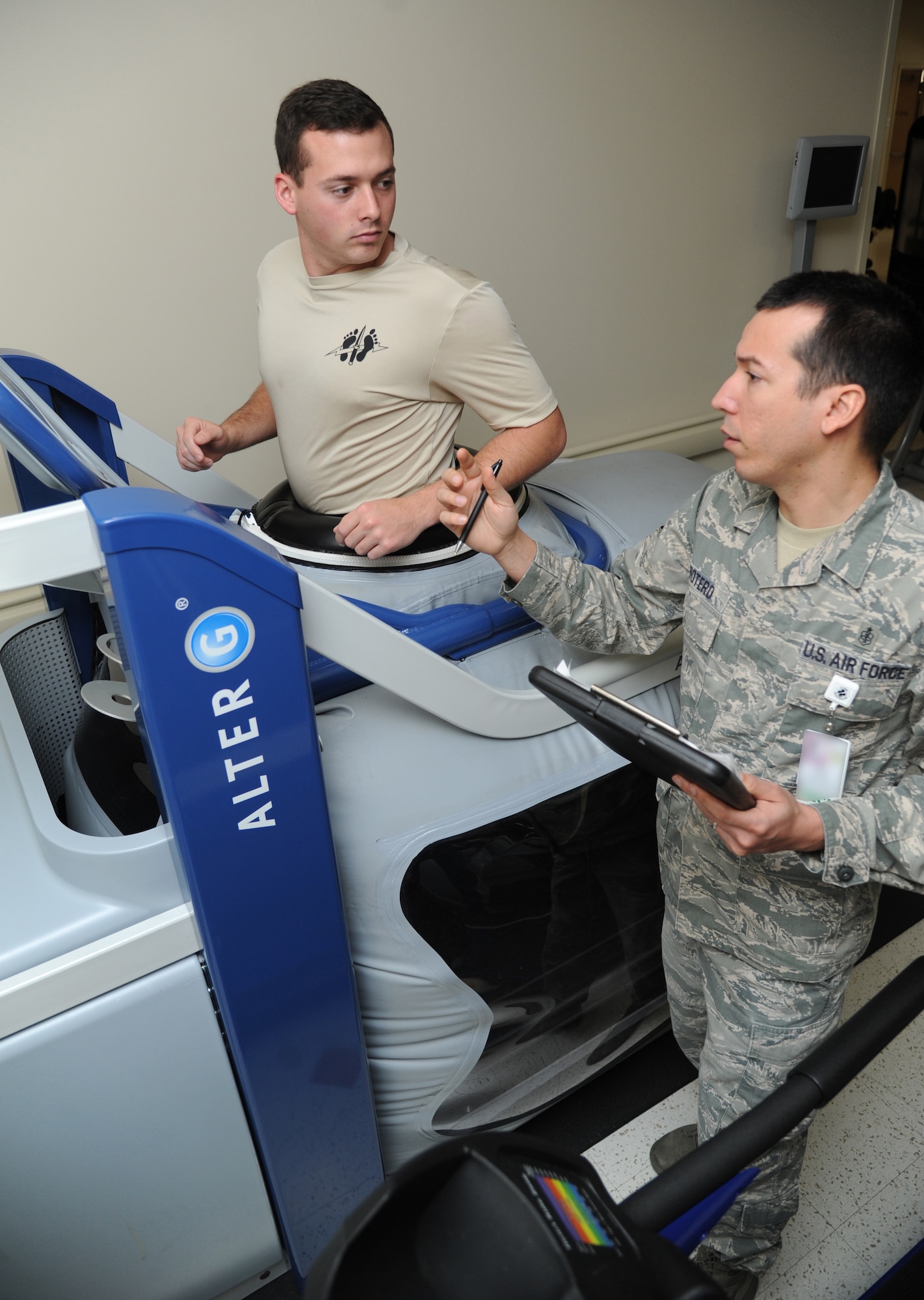 Airman 1st Class Terris Thompson, 335th Training Squadron special operations weather student, receives equipment instruction from Staff Sgt. Manuel Botero, 81st Surgical Operations Squadron physical medicine technician, March 4, 2015, at the Keesler Medical Center, Keesler Air Force Base, Miss. Botero assisted Thompson with utilizing an anti-gravity treadmill, which assists patients with returning to normal running after sustaining an injury or pain. Physical and occupational therapy is offered inside the medical clinic as well as at the Levitow Training Support Facility and Matero Hall to allow students direct access to them.  (U.S. Air Force photo by Kemberly Groue)