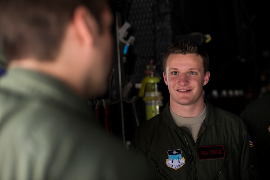 U.S. Air Force Cadet 4th Class Nick Forsythe, Cadet Squadron 9 (CS-09) from the U.S. Air Force Academy, Colo., speaks with a 71st Rescue Squadron loadmaster March 6, 2015, at Moody Air Force Base, Ga. The cadets toured Moody’s old and new C-130s and received mentorship from many 71st RQS loadmasters and pilots. (U.S. Air Force photo by Airman 1st Class Dillian Bamman/Released)