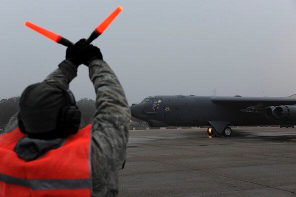 Airman Channing Edwards, 20th Aircraft Maintenance Unit crew chief, marshals a B-52H Stratofortress during a launch on Barksdale Air Force Base, La., March 3, 2015. Air Force Global Strike Command's continuing deployment of heavy bombers to Andersen AFB, Guam, demonstrates the command's ability to perform its nuclear deterrence mission, validating its commitment to global vigilance, security and reach. (U.S. Air Force photo/ Senior Airman Jannelle Dickey)