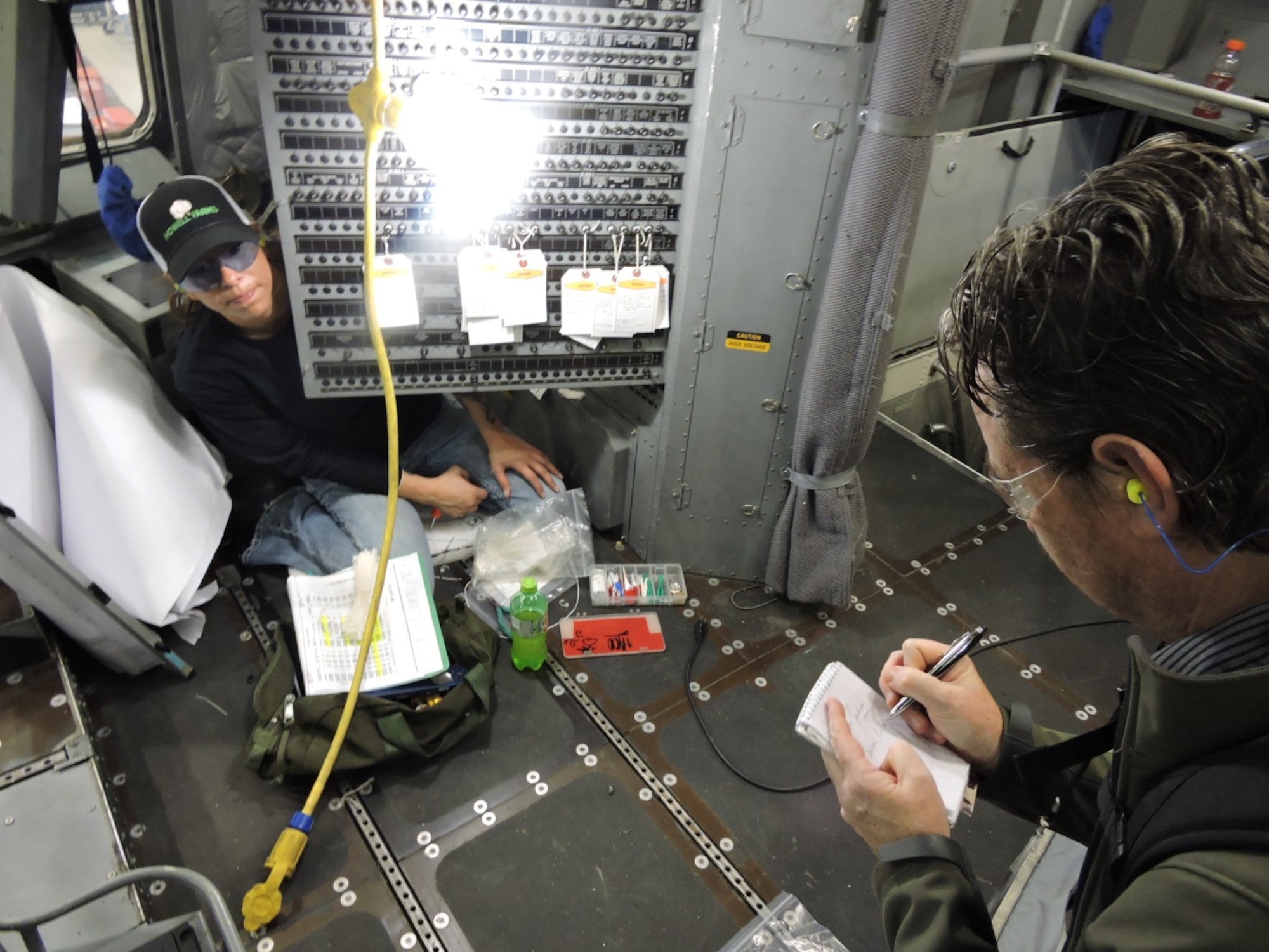 Sarah Collazo, 562nd Aircraft Maintenance Squadron aircraft electrician, left, installs new wiring to a circuit breaker panel as part of Block 16 modifications on a C-17 Globemaster. The Telegraph will feature the modification work in an upcoming article. (U.S. Air Force photo by Roland Leach)