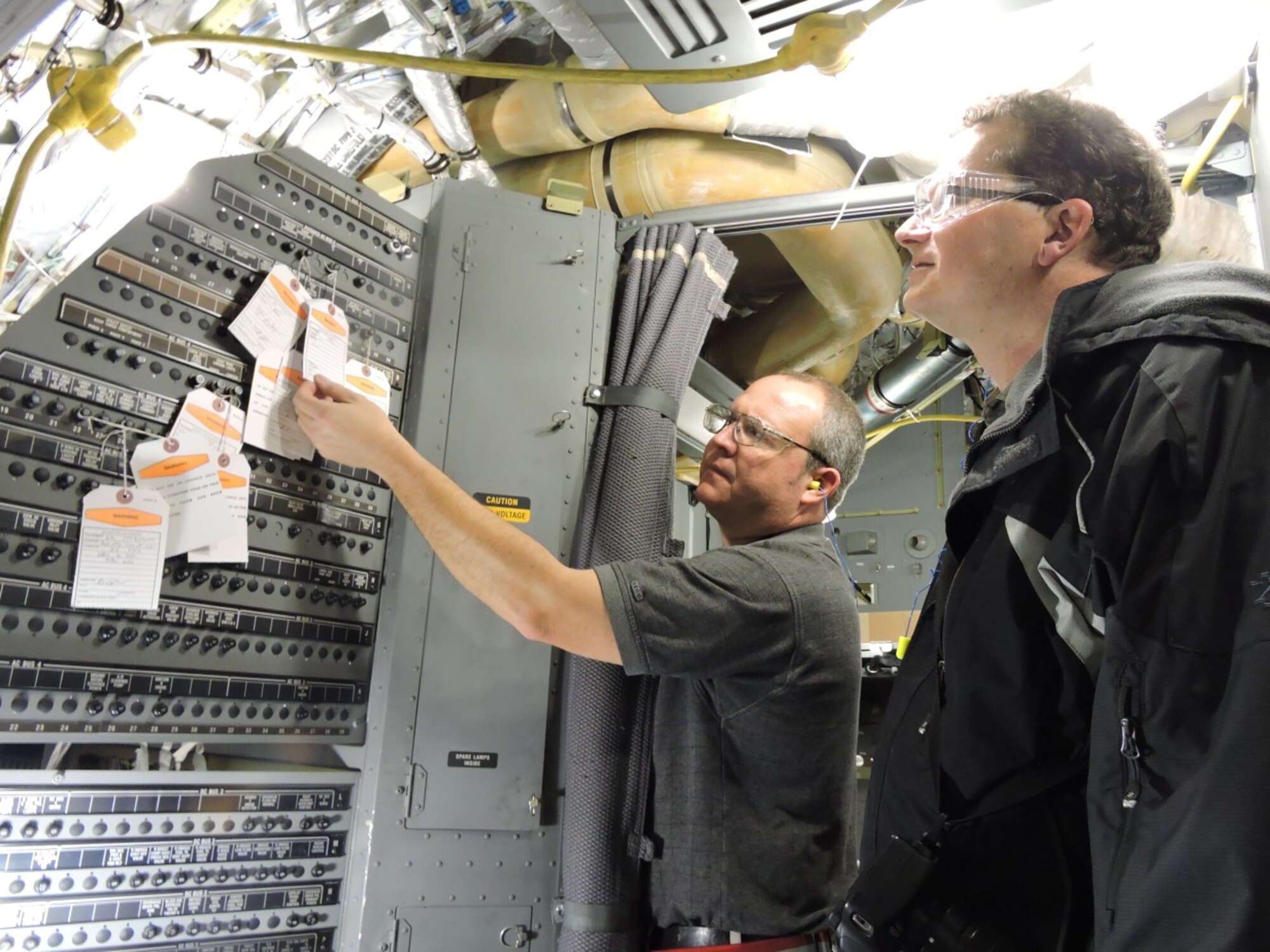 Jay Peavy, 562nd Aircraft Maintenance Squadron first-line supervisor, left, explains the electrical, component and structural work performed during recently completed Block 16 modifications on a C-17 Globemaster to Telegraph reporter Wayne Crenshaw. The Telegraph will feature the modification work in an upcoming article. (U.S. Air Force photo by Roland Leach)