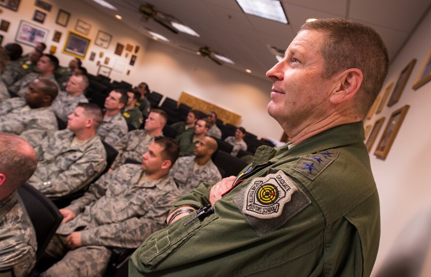 U.S. Air Force Gen. Robin Rand, commander of Air Education and Training Command, watches a video with members of the 81st Fighter Squadron during an all-call March 3, 2015, at Moody Air Force Base, Ga. Rand thanked the 81st FS for their work and commitment to the training mission. (U.S. Air Force photo by Airman 1st Class Ceaira Tinsley/Released)