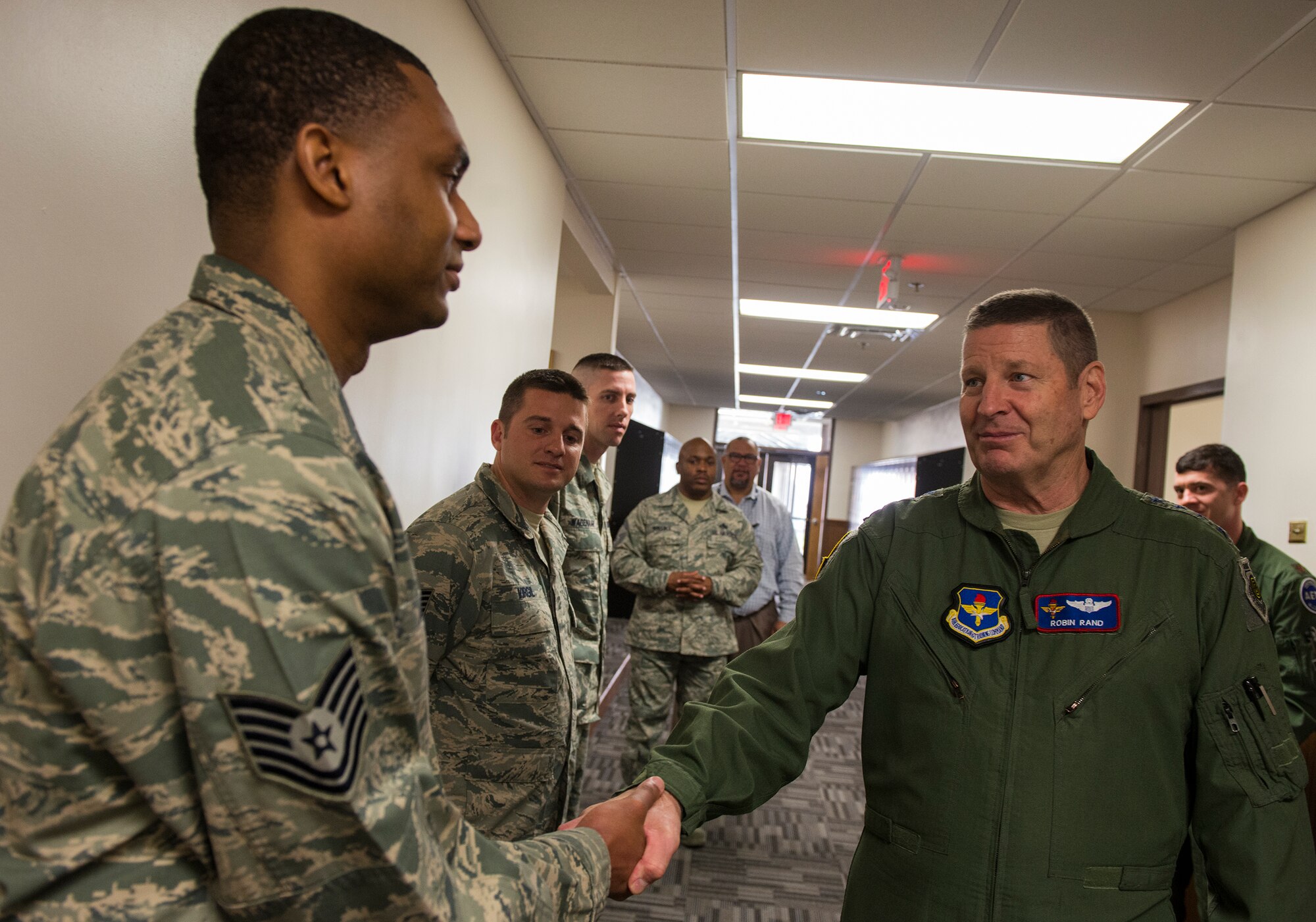 U.S. Air Force Gen. Robin Rand, commander of Air Education and Training Command, coins Tech. Sgt. Markus Anthony, 81st Fighter Squadron A-29 Super Tucano avionics air advisor, March 3, 2015, at Moody Air Force Base, Ga. Rand also coined Afghan pilots and five members of the 81st FS for being among the “best of the best.” (U.S. Air Force photo by Airman 1st Class Ceaira Tinsley/Released)