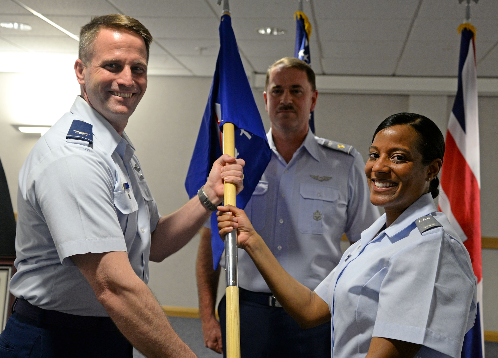 U.S. Air Force Senior Master Sgt. Shareen Taylor, right, 100th Operations Support Squadron interim superintendent from Tucson, Ariz, receives the unit’s guidon from U.S. Air Force Col. David Cox, left, 100th Air Refueling Wing vice commander, during a Civil Air Patrol squadron activation ceremony March 2, 2015, on RAF Mildenhall, England. CAP, an all-volunteer organization, is the civilian Auxiliary of the U.S. Air Force and performs services for the federal government by providing aerospace education of the American public, performing emergency services support and conducting a cadet training program. (U.S. Air Force photo by Senior Airman Christine Griffiths/Released)