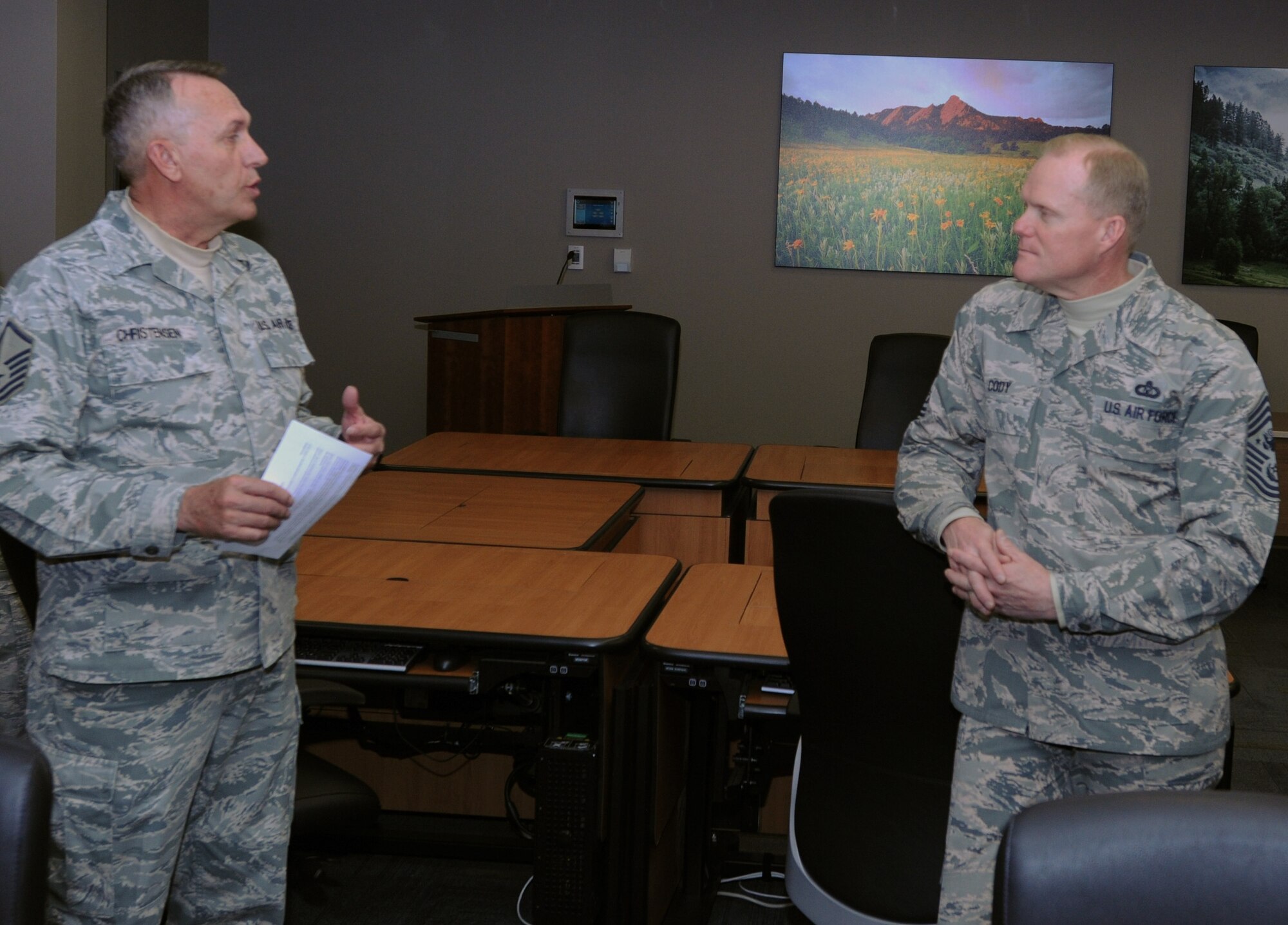 Chief Master Sgt. of the Air Force James A. Cody listens to Master Sgt. Jon Christensen, Air Reserve Personnel Center requirements systems analyst, during his visit to ARPC March 5, 2015, on Buckley Air Force Base, Colo. Cody’s visit focused on the future of the Air Force as he met with Airmen and discussed his role and priorities. (U.S. Air Force photo/Tech. Sgt. Rob Hazelett)