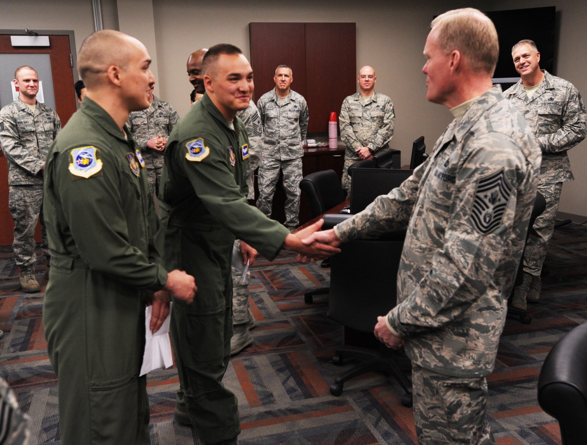 Chief Master Sgt. of the Air Force James A. Cody meets Senior Airmen Adam Van Horn and Evan Van Horn, Air Reserve Personnel Center points management technicians, during his visit to ARPC March 5, 2015, on Buckley Air Force Base, Colo. Cody’s visit focused on the future of the Air Force as he met with Airmen and discussed his role and priorities. (U.S. Air Force photo/Tech. Sgt. Rob Hazelett)
