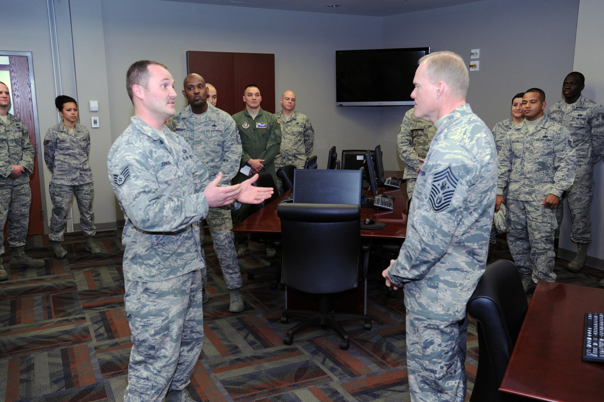 Chief Master Sgt. of the Air Force James A. Cody listens to Staff Sgt. Andrew Johnson, Air Reserve Personnel Center accessions branch NCO in charge, during his visit to ARPC March 5, 2015, on Buckley Air Force Base, Colo. Cody’s visit focused on the future of the Air Force as he met with Airmen and discussed his role and priorities. (U.S. Air Force photo/Tech. Sgt. Rob Hazelett)