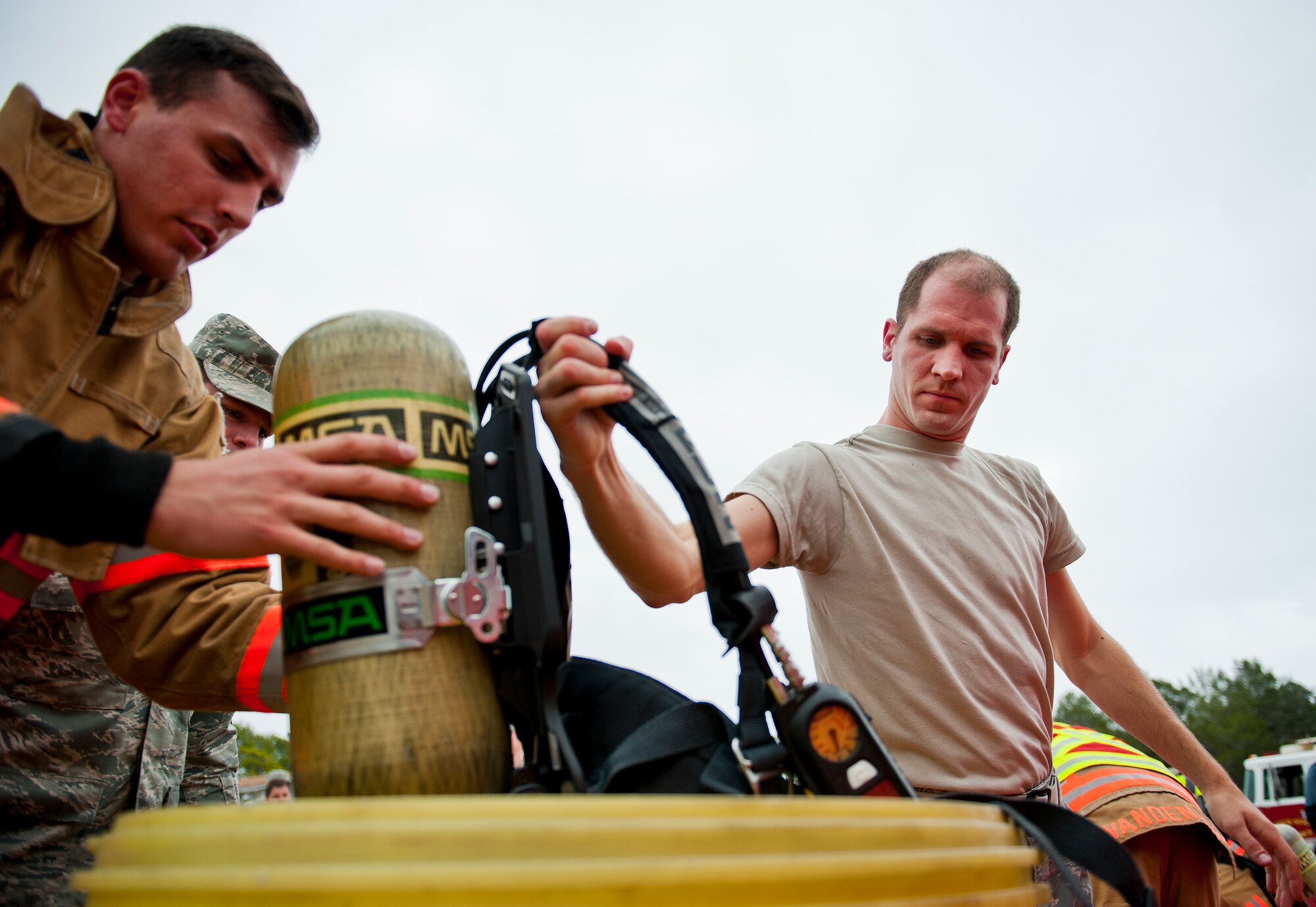 Senior Airman Anthony Guciardo, of the 96th Bioenvironmental Flight, places his oxygen tank into the contamination bin during the decontamination process at the 96th Civil Engineer Group training exercise March 2.  The exercise was part of annual training for firefighters, explosive ordnance disposal, emergency management and the 96th Medical Group’s bioenvironmental flight.  The training scenario of a chemical-emitting bomb threat tasked all of the units involved from first response and contaminant detection to bomb deactivation.  (U.S. Air Force photo/Samuel King Jr.)