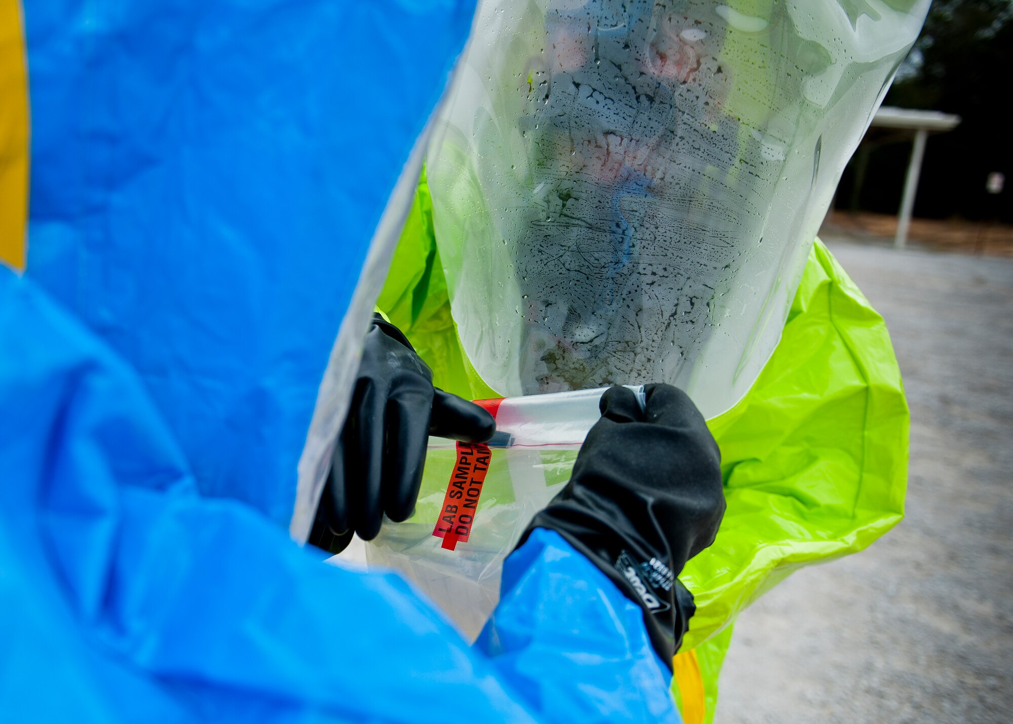 Bioenvironmental and emergency management personnel seal up a contaminated sample for further test during a 96th Civil Engineer Group training exercise March 2.  The exercise was part of annual training for firefighters, explosive ordnance disposal, emergency management and the 96th Medical Group’s bioenvironmental flight.  The training scenario of a chemical-emitting bomb threat tasked all of the units involved from first response and contaminant detection to bomb deactivation.  (U.S. Air Force photo/Samuel King Jr.)