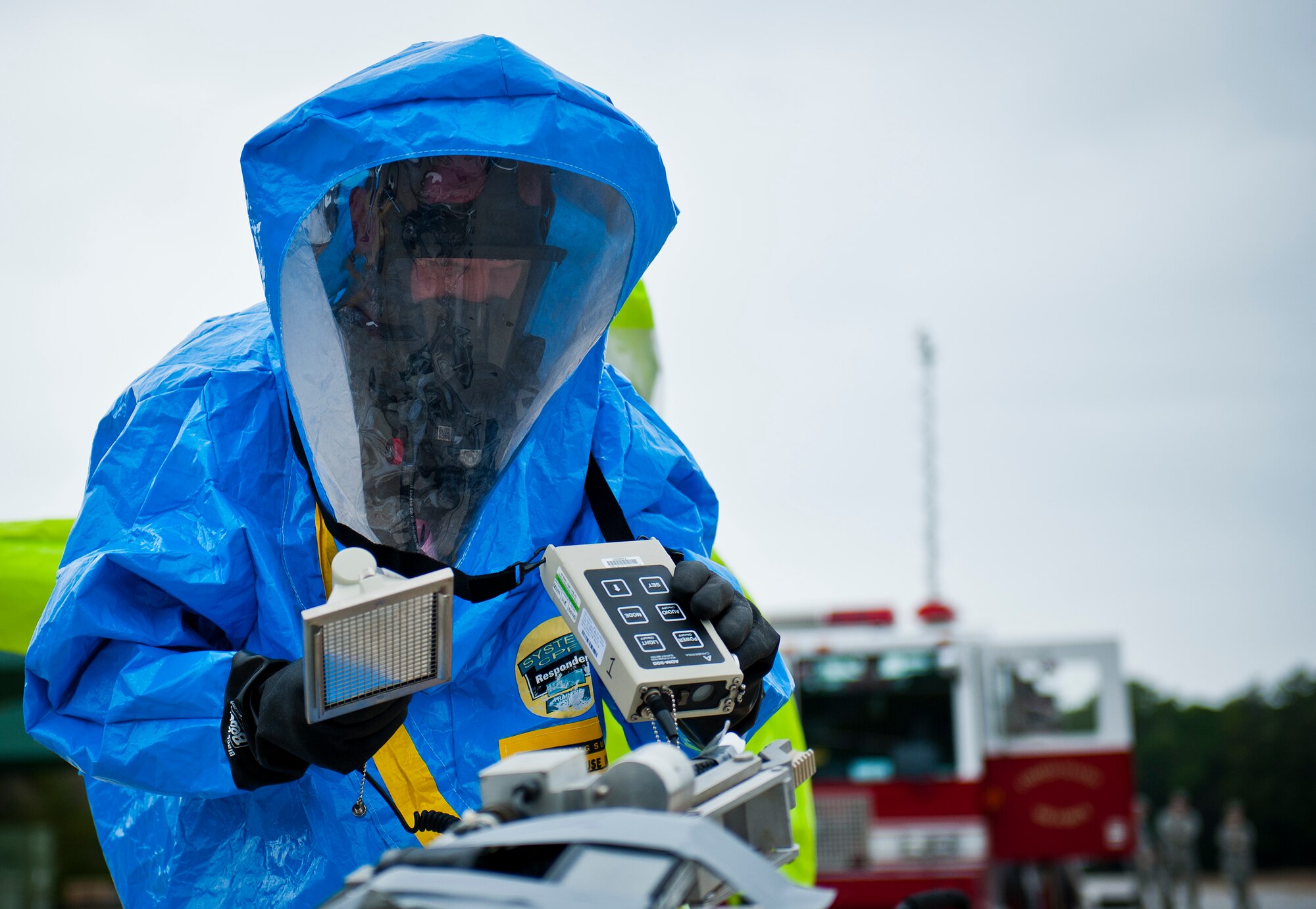 Senior Airman Anthony Guciardo, of the 96th Bioenvironmental Flight, scans the chemical sample retrieved by an explosive ordnance disposal robot with the ADM 300 device during a 96th Civil Engineer Group training exercise March 2.  The exercise was part of annual training for firefighters, explosive ordnance disposal, emergency management and the bioenvironmental flight.  The training scenario of a chemical-emitting bomb threat tasked all of the units involved from first response and contaminant detection to bomb deactivation.  (U.S. Air Force photo/Samuel King Jr.)