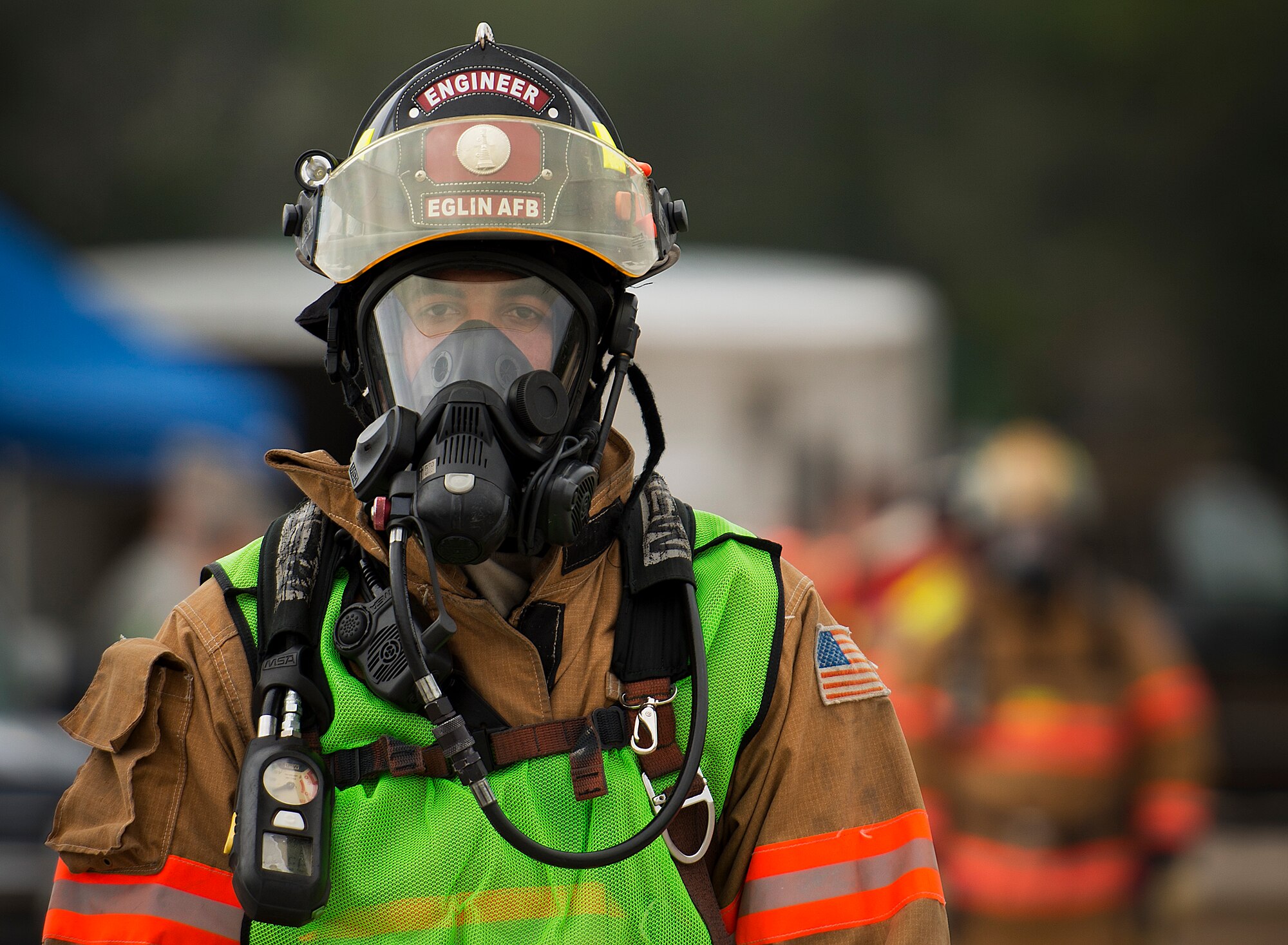 An Eglin Air Force Base firefighter stands by during a 96th Civil Engineer Group training exercise March 2.  The exercise was part of annual training for firefighters, explosive ordnance disposal, emergency management and the 96th Medical Group’s bioenvironmental flight.  The training scenario of a chemical-emitting bomb threat tasked all of the units involved from first response and contaminant detection to bomb deactivation.  (U.S. Air Force photo/Samuel King Jr.)