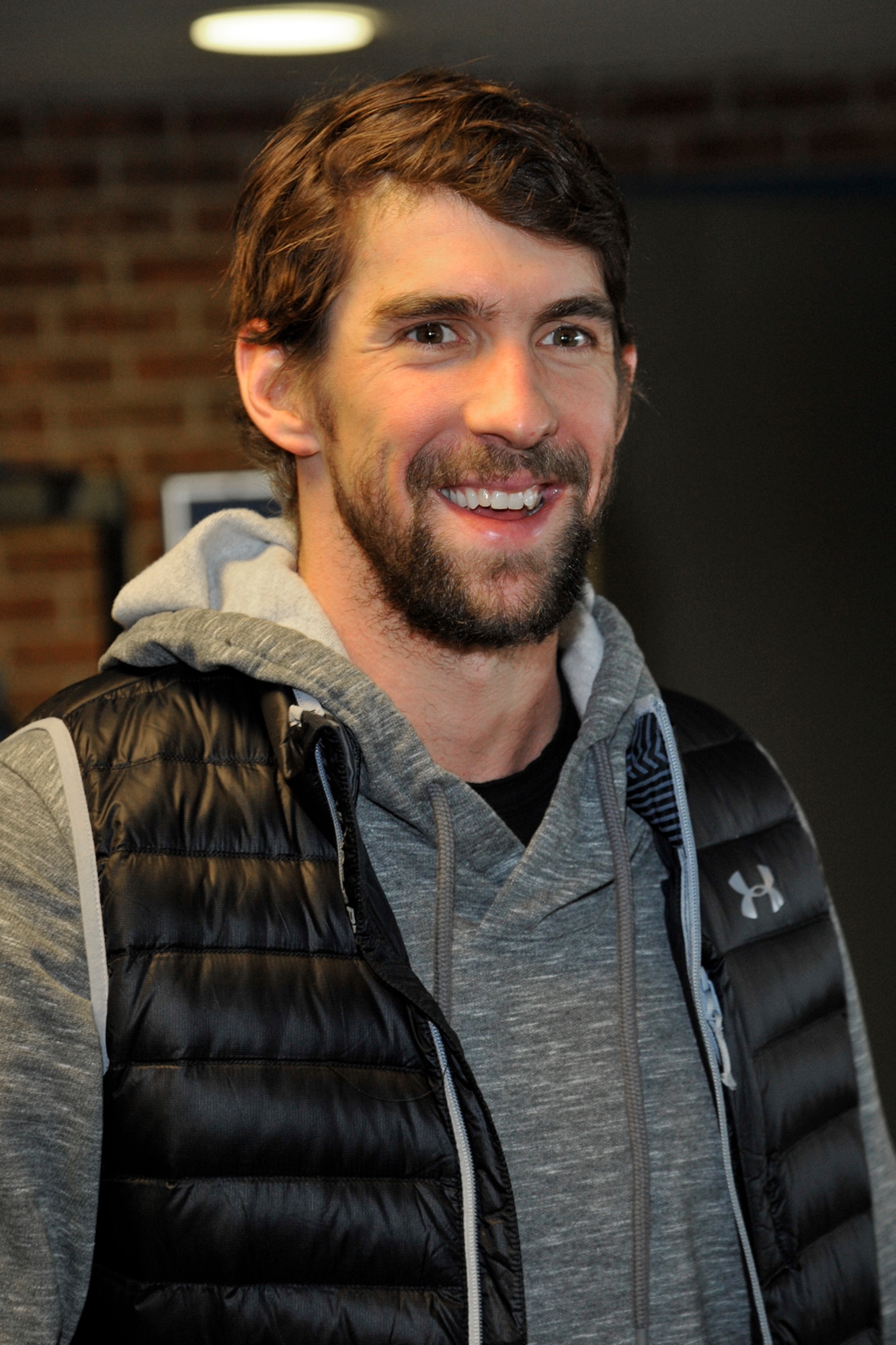 PETERSON AIR FORCE BASE, Colo. – Michael Phelps, 22-time Olympic medalist in swimming, visits with Team Pete im8 swim program participants at the pool March 2, 2015. Phelps came to see the program in action with the swim instructors teaching the im safe module to 14 kids, and taught the kids a few tricks of his own to master their swimming techniques. (U.S. Air Force photo by Robert Lingley)