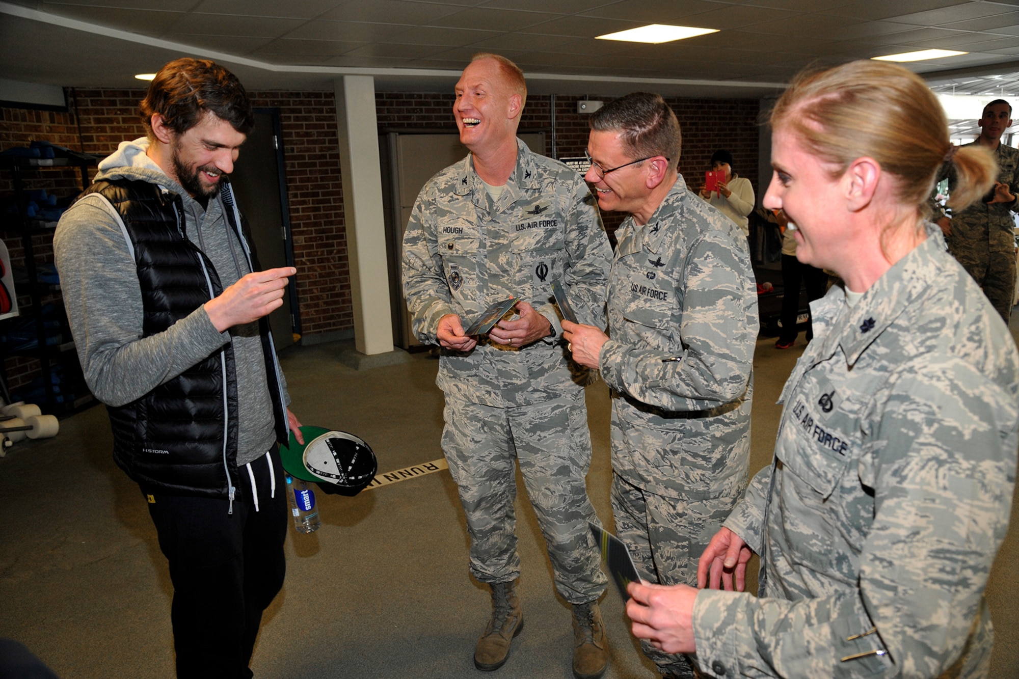PETERSON AIR FORCE BASE, Colo. – Michael Phelps, 22-time Olympic medalist in swimming, meets with Col. Michael Hough, 21st Space Wing vice commander, Col. Reginald Ash III, 21st Mission Support Group commander, and Lt. Col. Tammy Schlichenmaier, 21st Force Support Squadron commander, during his visit with the im8 swim program participants at the pool March 2, 2015. Phelps came to see the program in action with the swim instructors teaching the im safe module to 14 kids, and taught the kids a few tricks of his own to master their swimming techniques. (U.S. Air Force photo by Robert Lingley)