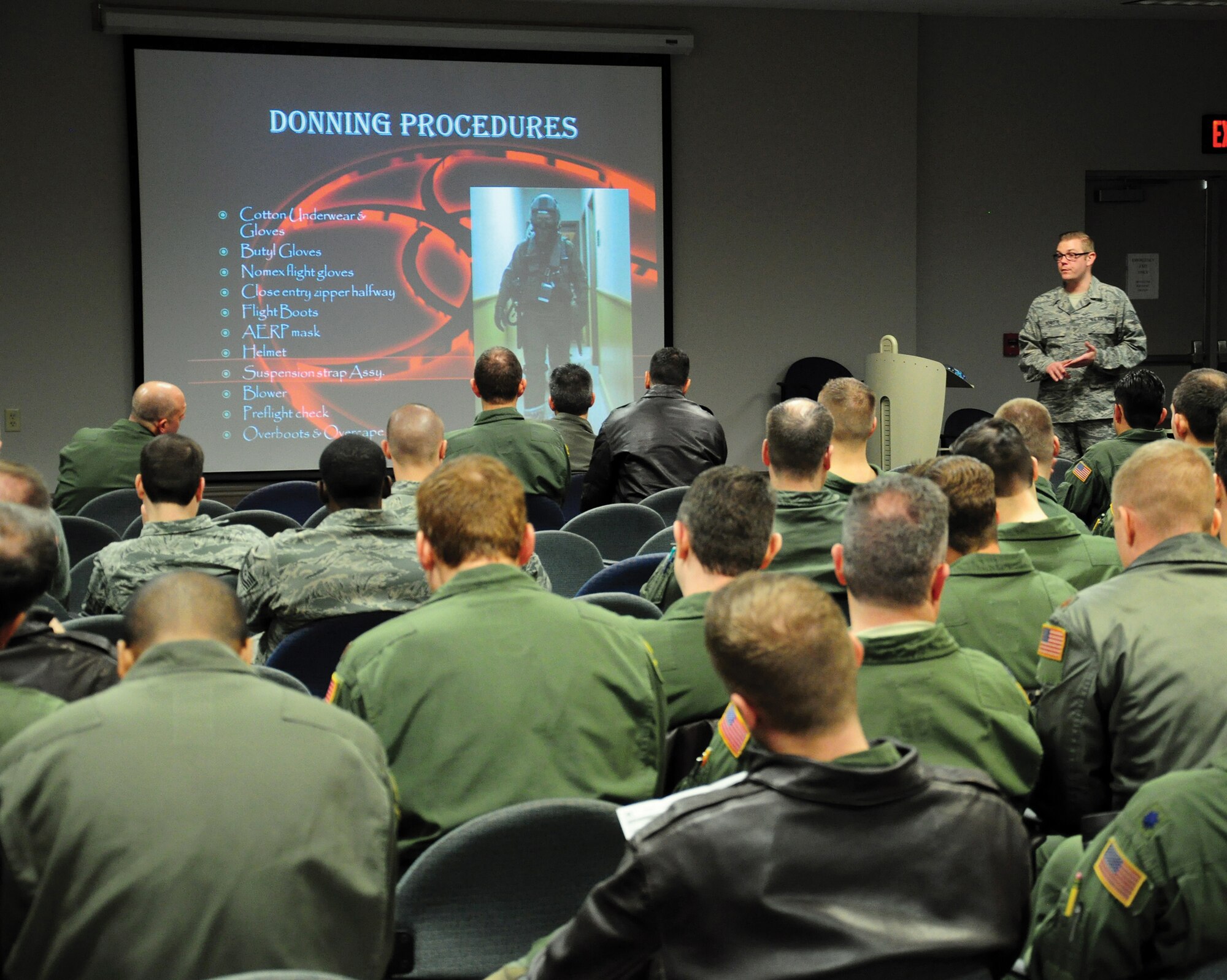 WRIGHT-PATTERSON AIR FORCE BASE, Ohio - Tech. Sgt. Austin Schutte, 445th Operations Support Squadron aircrew flight equipment craftsman, instructs 89th Airlift Squadron Airmen on donning procedures during the Feb. 7 unit training assembly. (U.S. Air Force photo/Tech. Sgt. Patrick O'Reilly)