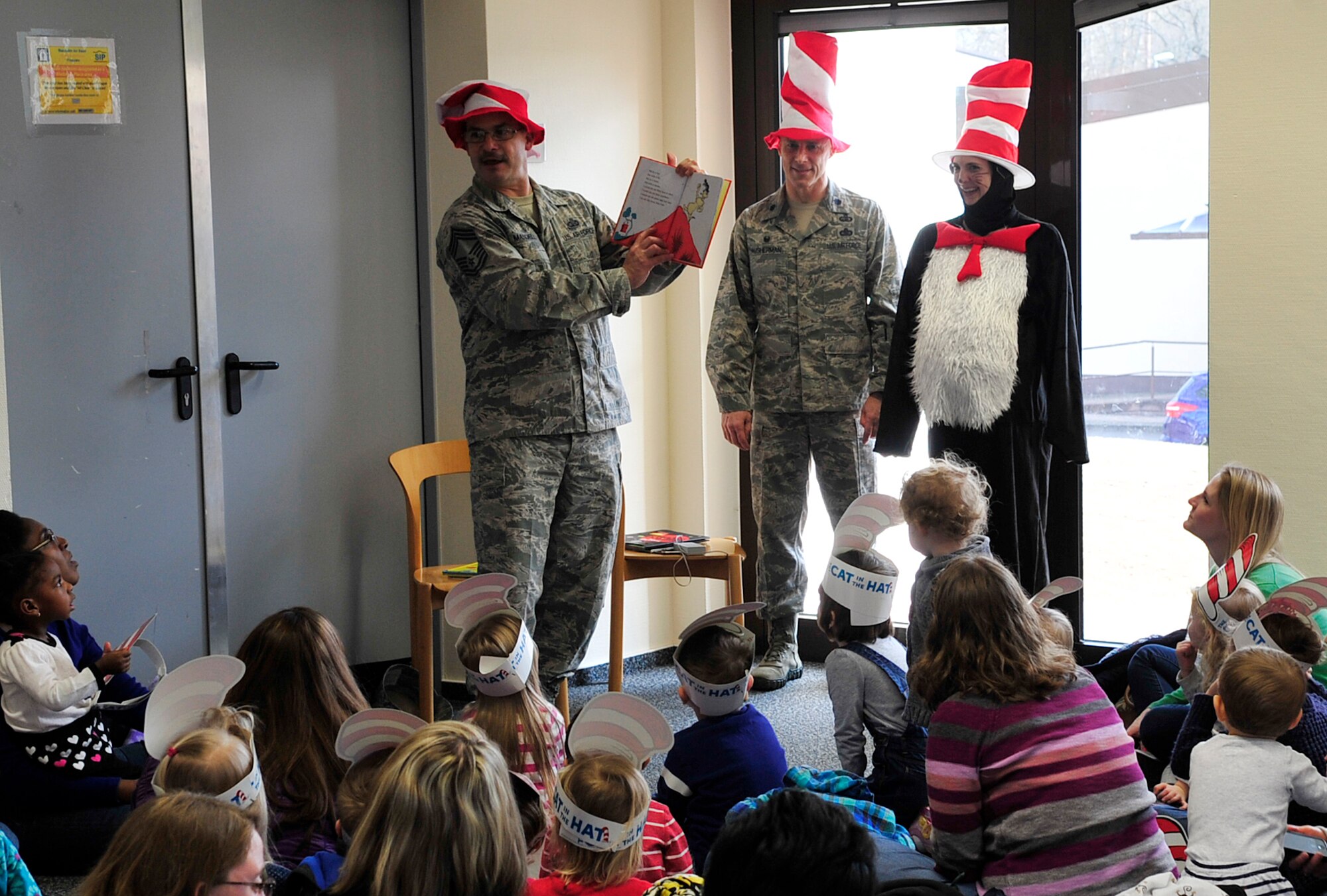 Chief Master Sgt. Steven Mandell, 86th Force Support Squadron superintendent, reads Dr. Seuss’s “Green Eggs and Ham” to children and their parents during Read Across America, March 5, 2015, at Ramstein Air Base, Germany. The event consisted of story-time, snacks and free books for the children. (U.S. Air Force photo/Airman 1st Class Larissa Greatwood)