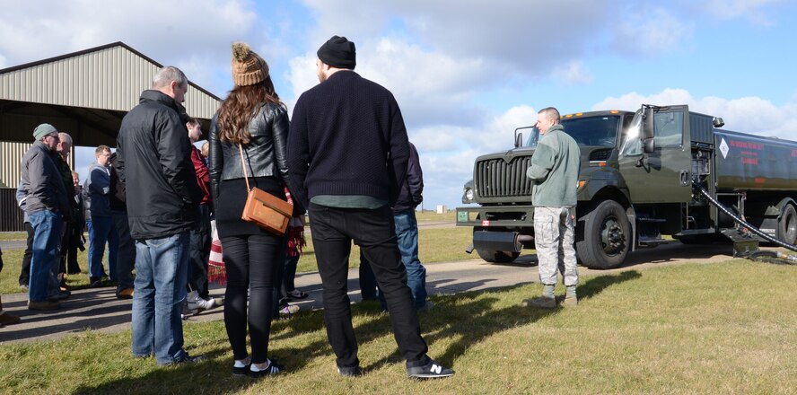 U.S. Air Force Master Sgt. Carl Boswell, right, 100th Logistics Readiness Squadron Fuels Operations section chief from Orlando, Fla., provides civilians from the 100th LRS a tour of the fuels flight during a Civilian Appreciation Day tour Feb. 27, 2015, on RAF Mildenhall, England. The guests received an explanation of what the fuels flight does and their role in the mission. (U.S. Air Force photo by Gina Randall/Released)